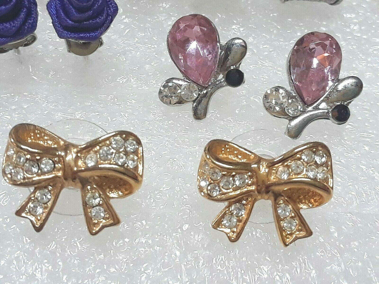 Pierced earrings with stones. pink, purple, clear. gold tone silver tone. 8 pair