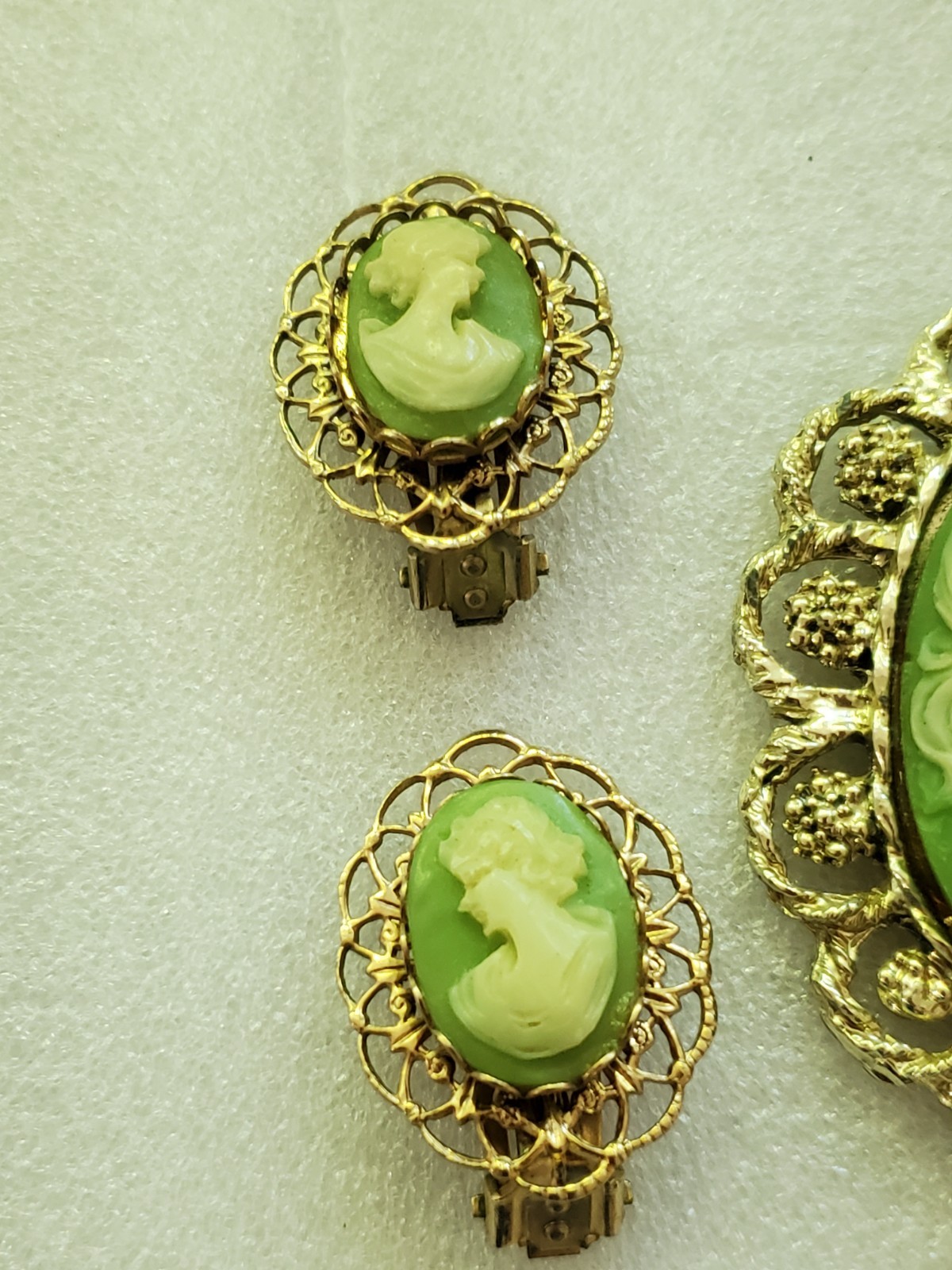 Gold-tone metal green/ivory plastic/resin cameo pendant & clip on earrings