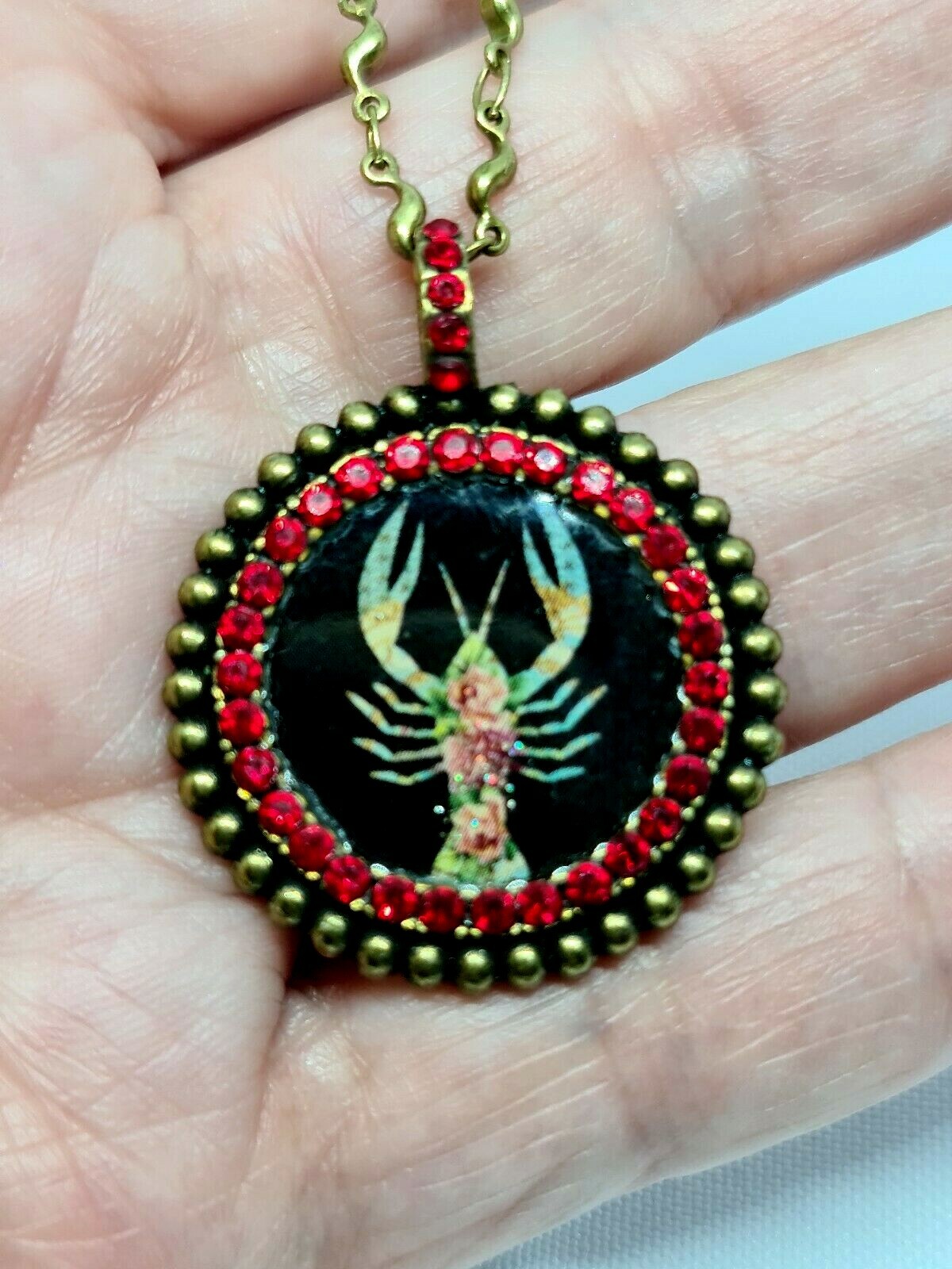 Lovely round Metal Necklace By Michal Negrin Red Crystal Cancer Sign.