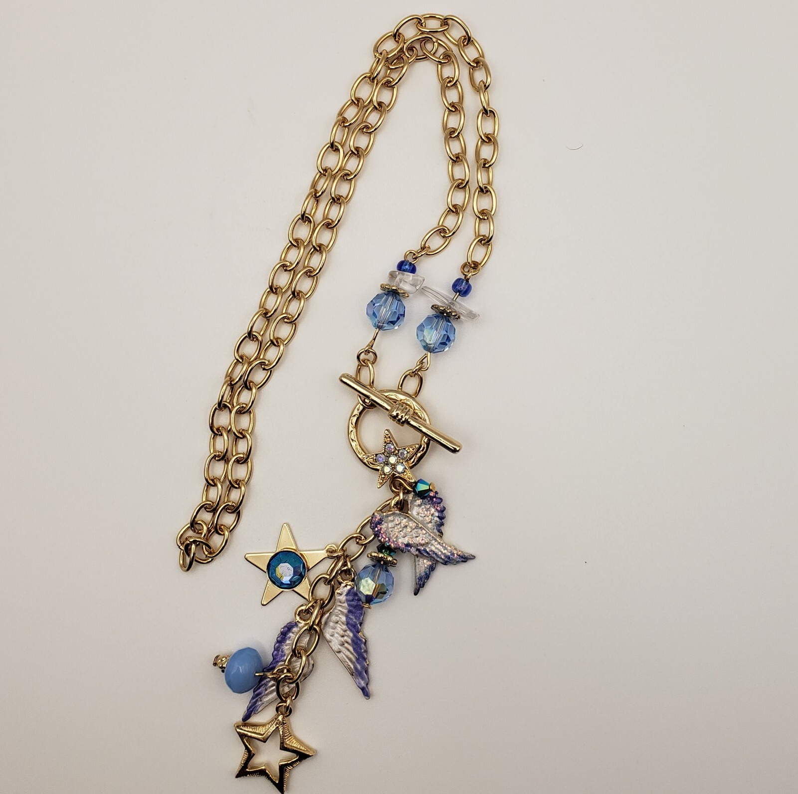 Kirks Folly Forever Angel Wings Charm Necklace Gold Tone 17in Long Blue Crystals