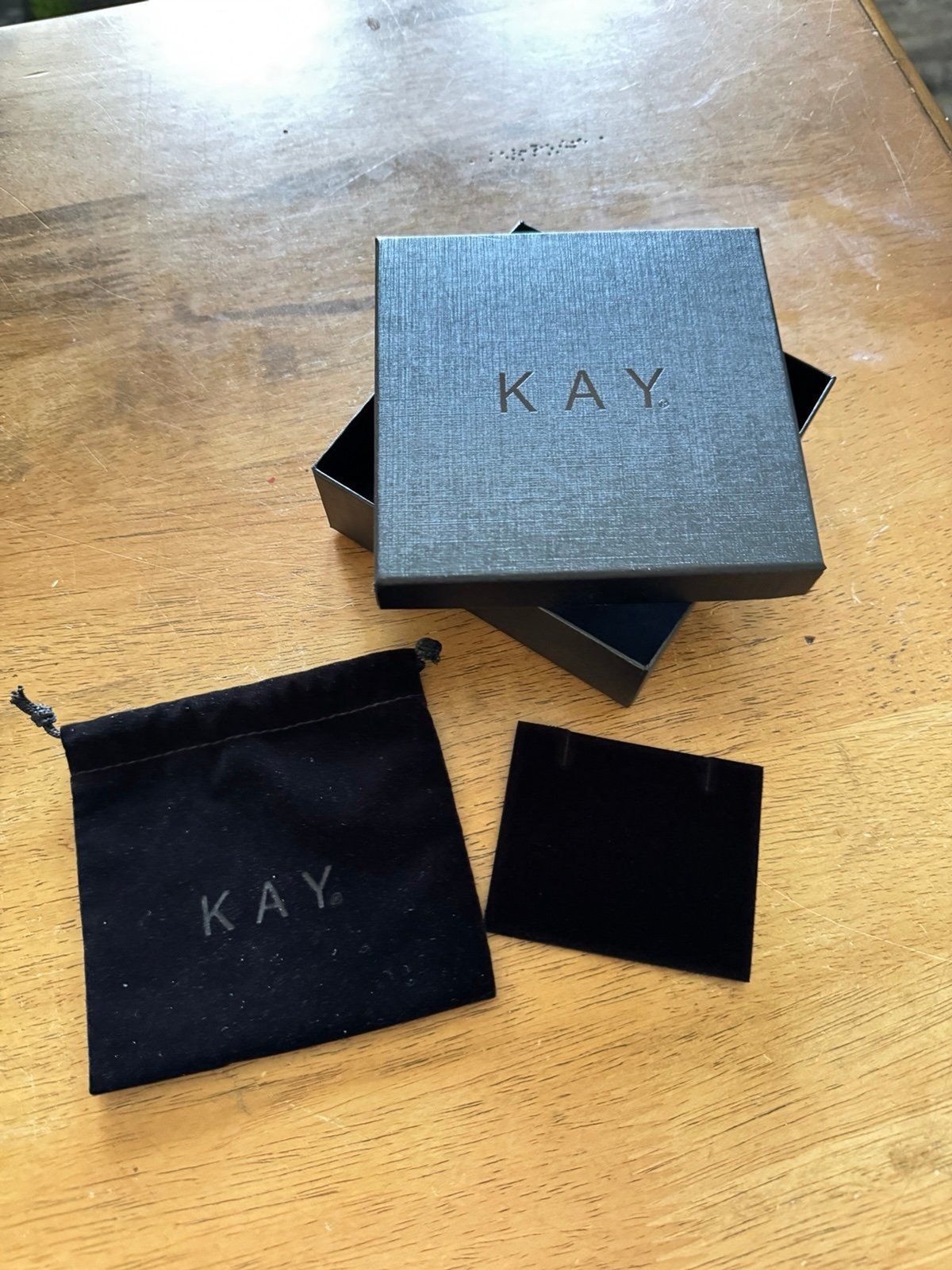 Kay Jewelers presentation box set, featuring a black branded box, a velvet pouch