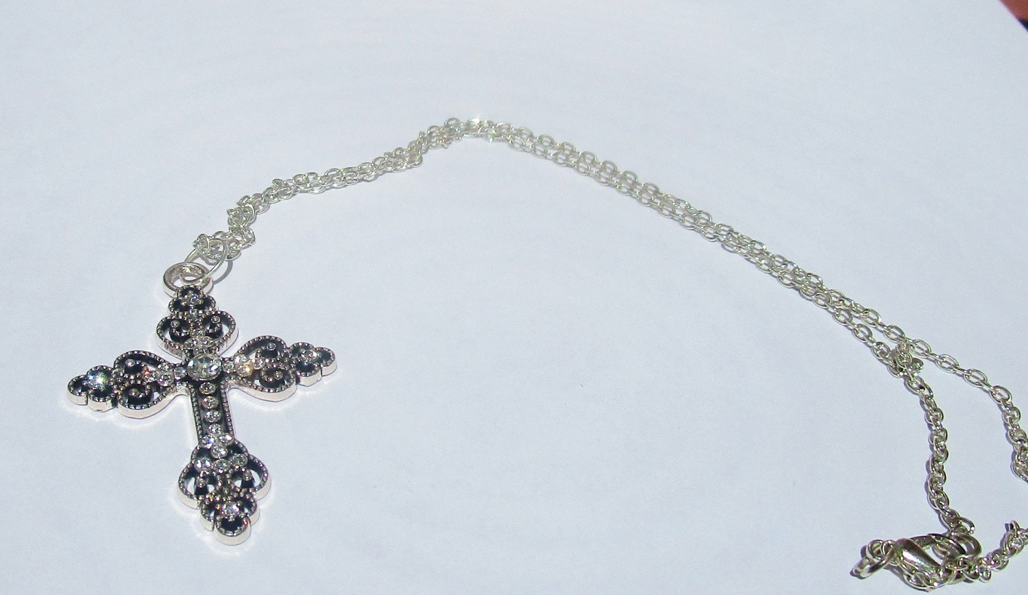 silver color ornate cross necklace for women