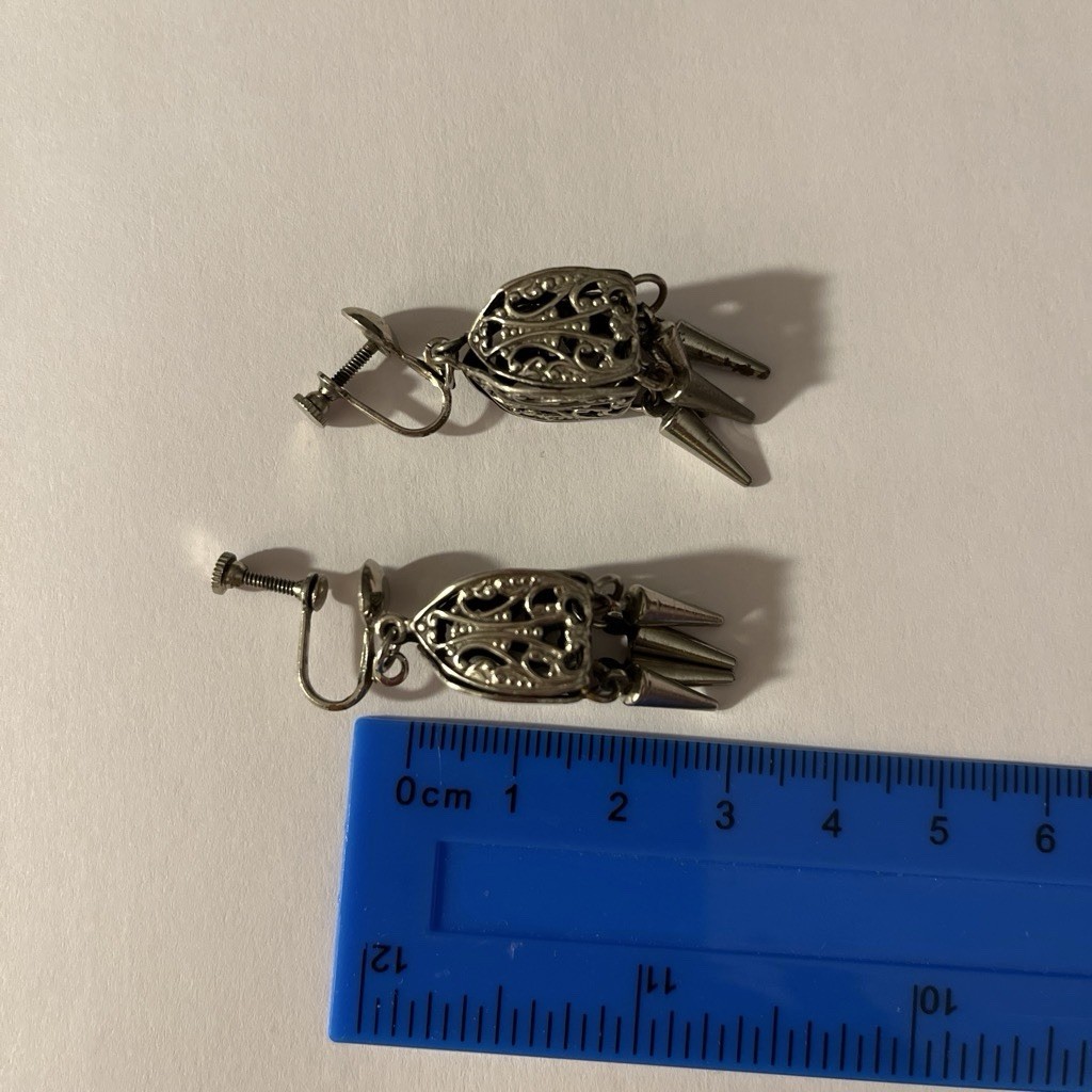 Silver Tone Earrings With Filigree Design And Dangling Spike