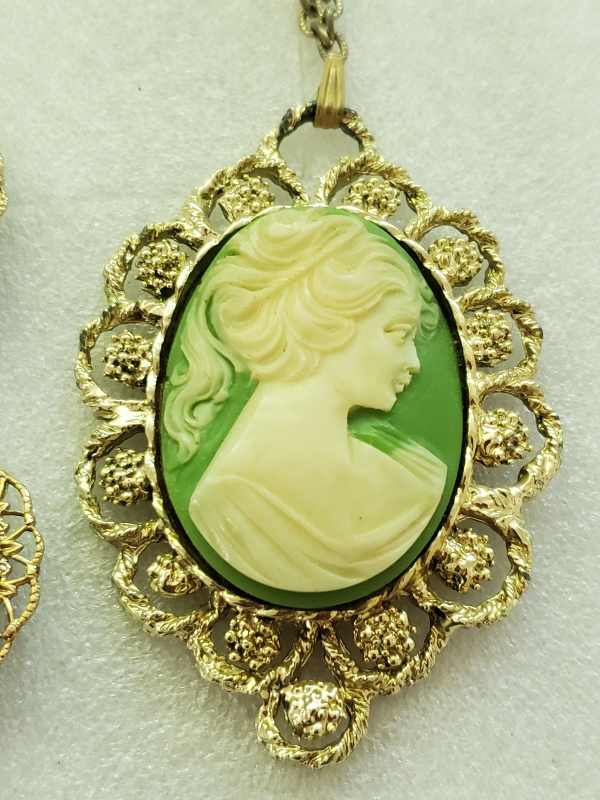 Gold-tone metal green/ivory plastic/resin cameo pendant & clip on earrings