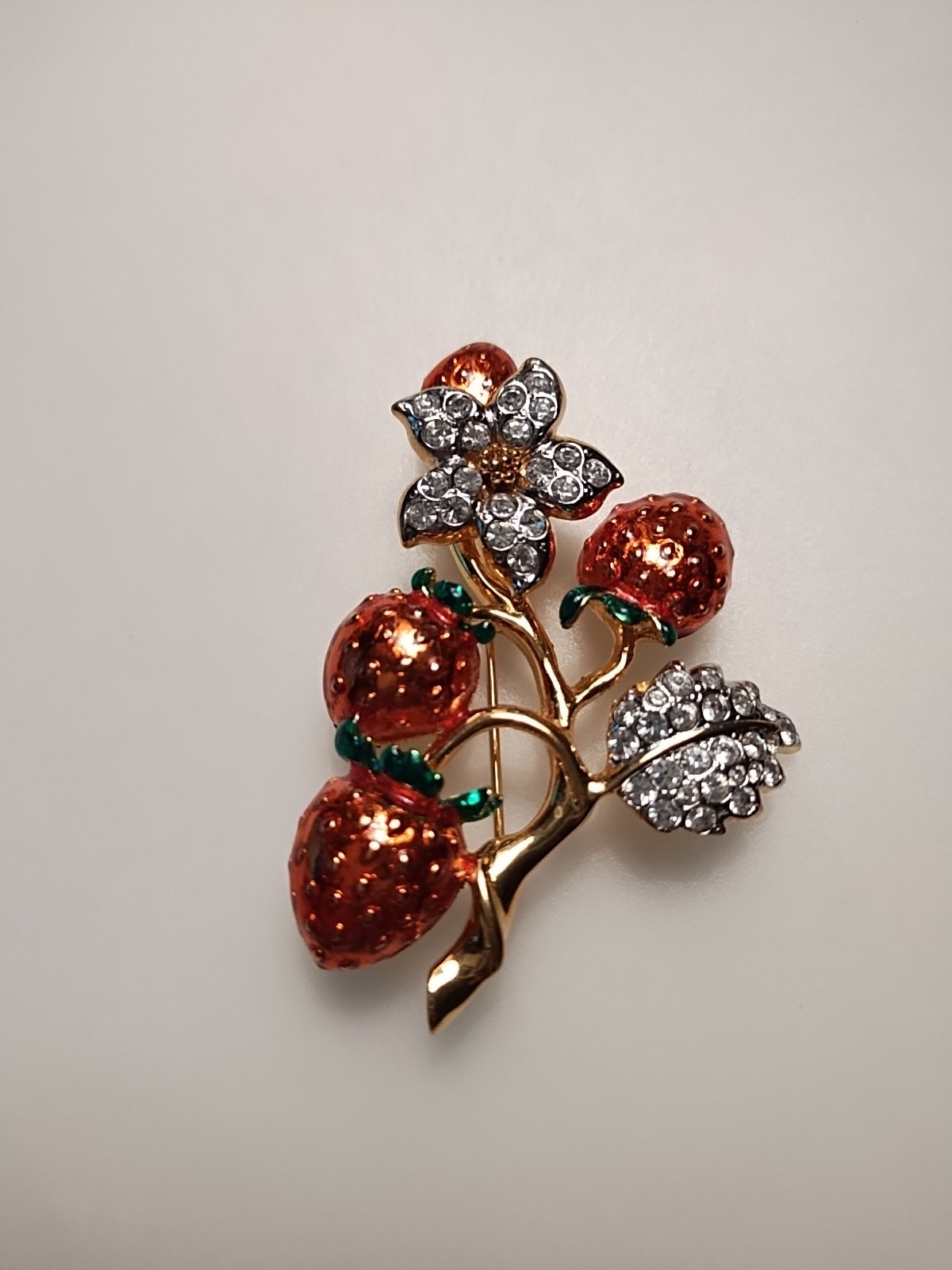 Gold Tone Strawberry broch with enamel strawberry and rhinestone Leafs 2 inch