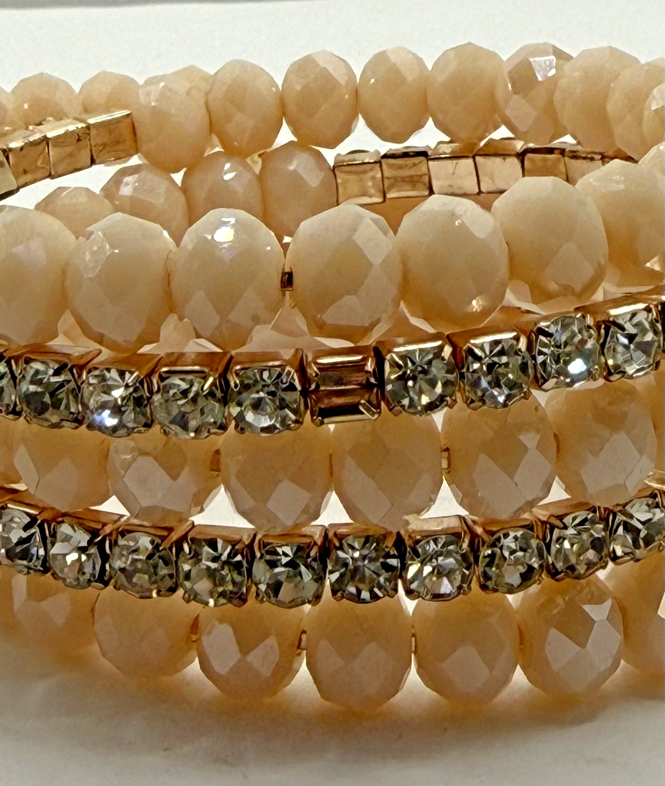 5 row crystal and gemstone coil layered bracelet 1 stone missing INC in box