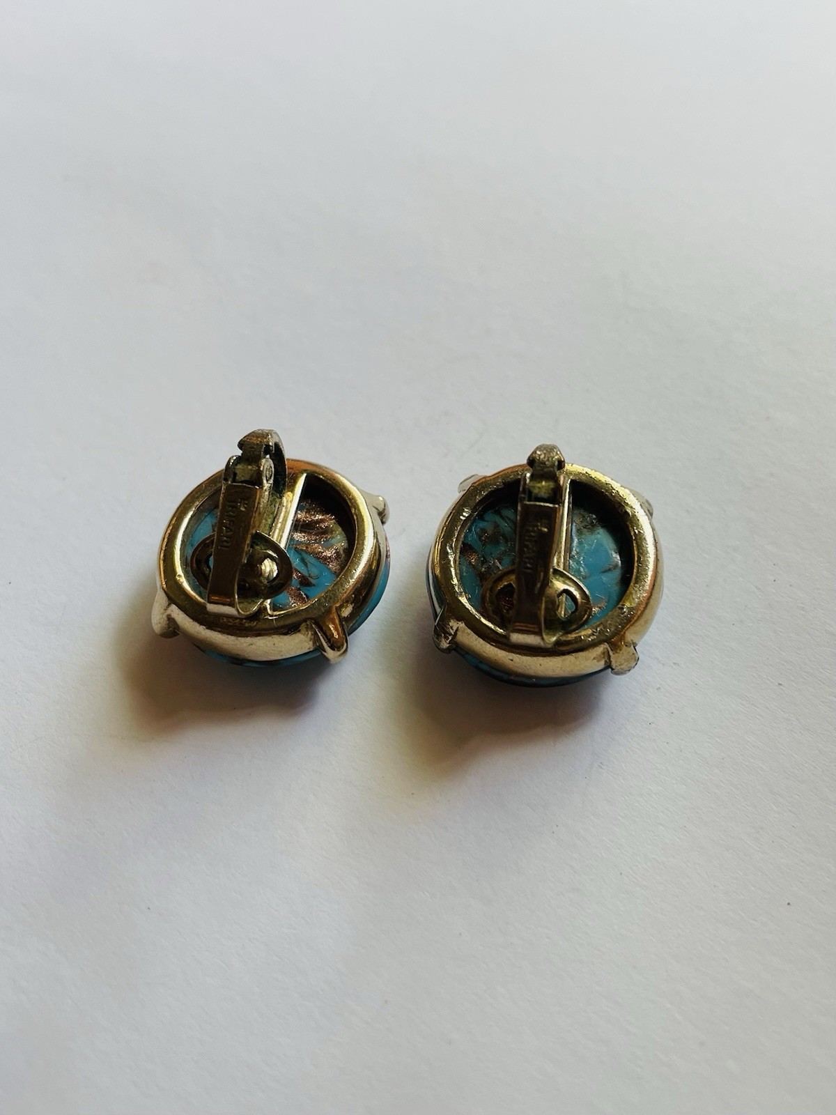 Vintage Crown Trifari round clip-on earrings, featuring turquoise cabochon