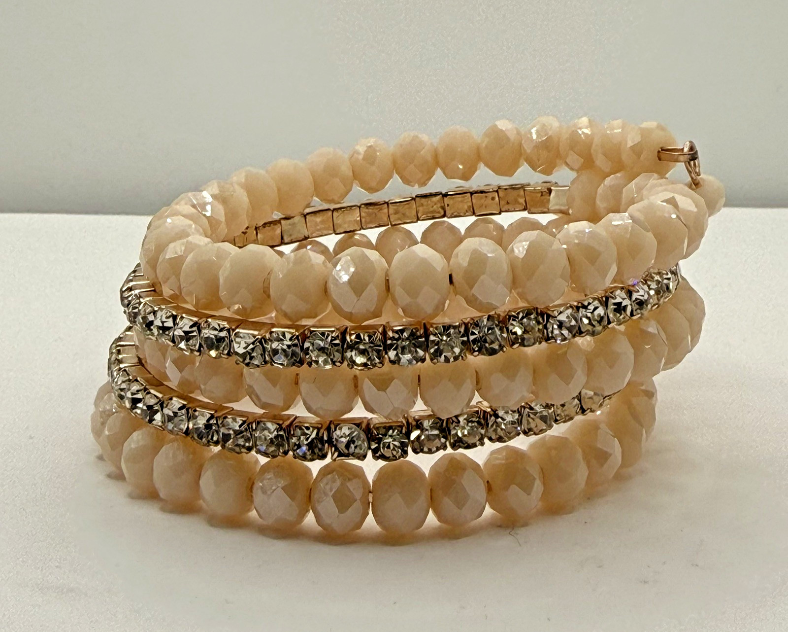 5 row crystal and gemstone coil layered bracelet 1 stone missing INC in box