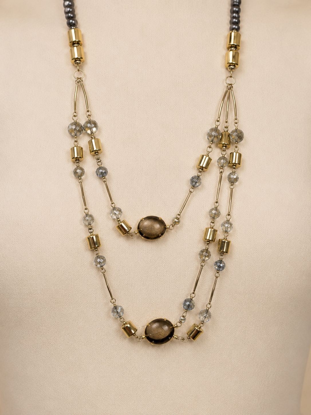 Silver-colored multi-strand crystal necklace in light blue, transparent, and gra