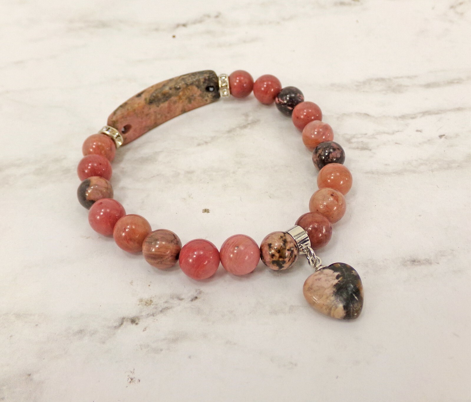 Pink heart charm bracelet made in rhodonite stone beads and crystal spacer beads