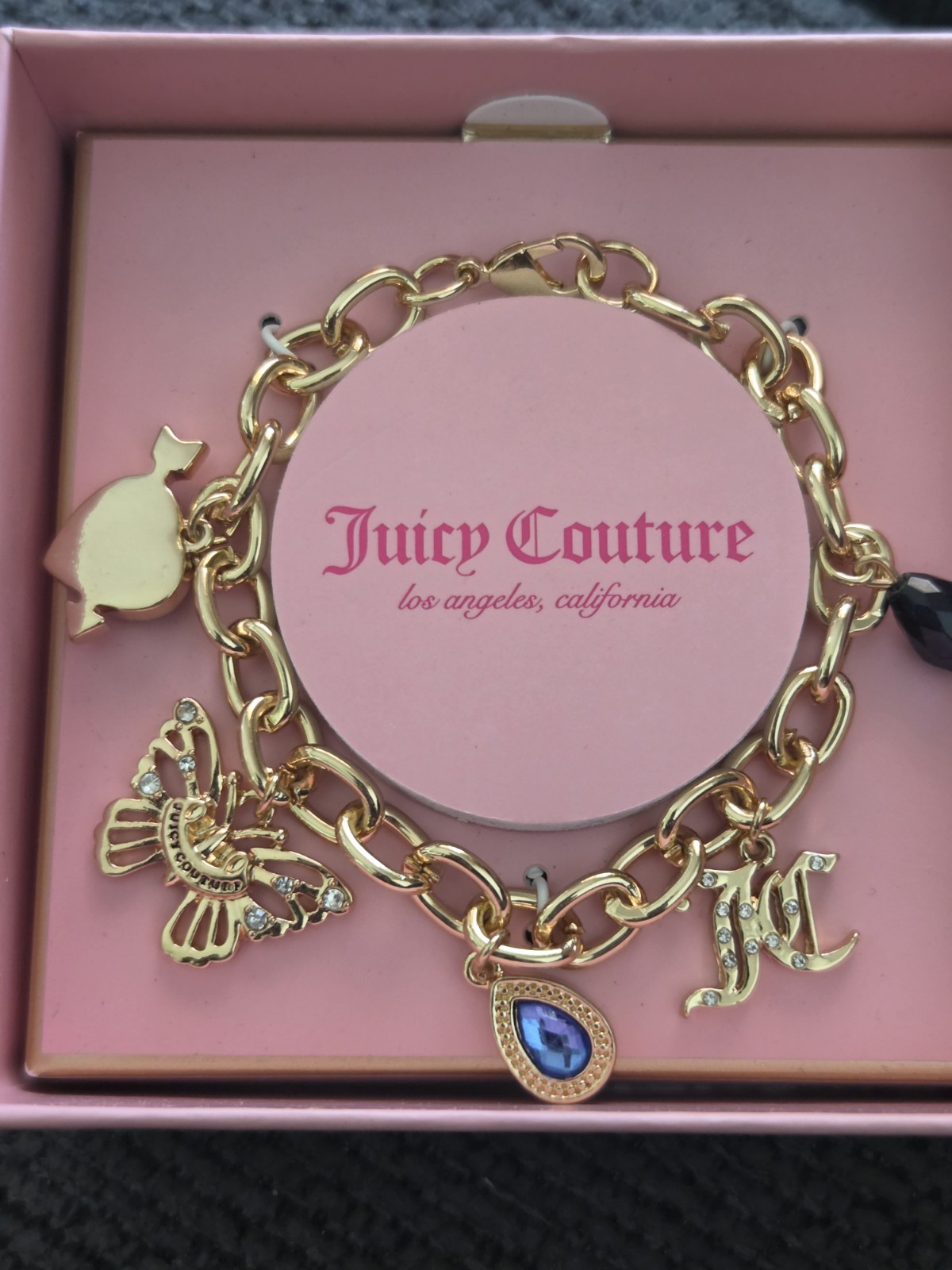 Juicy Couture Gold Charm Bracelet with Blue and Black Accents