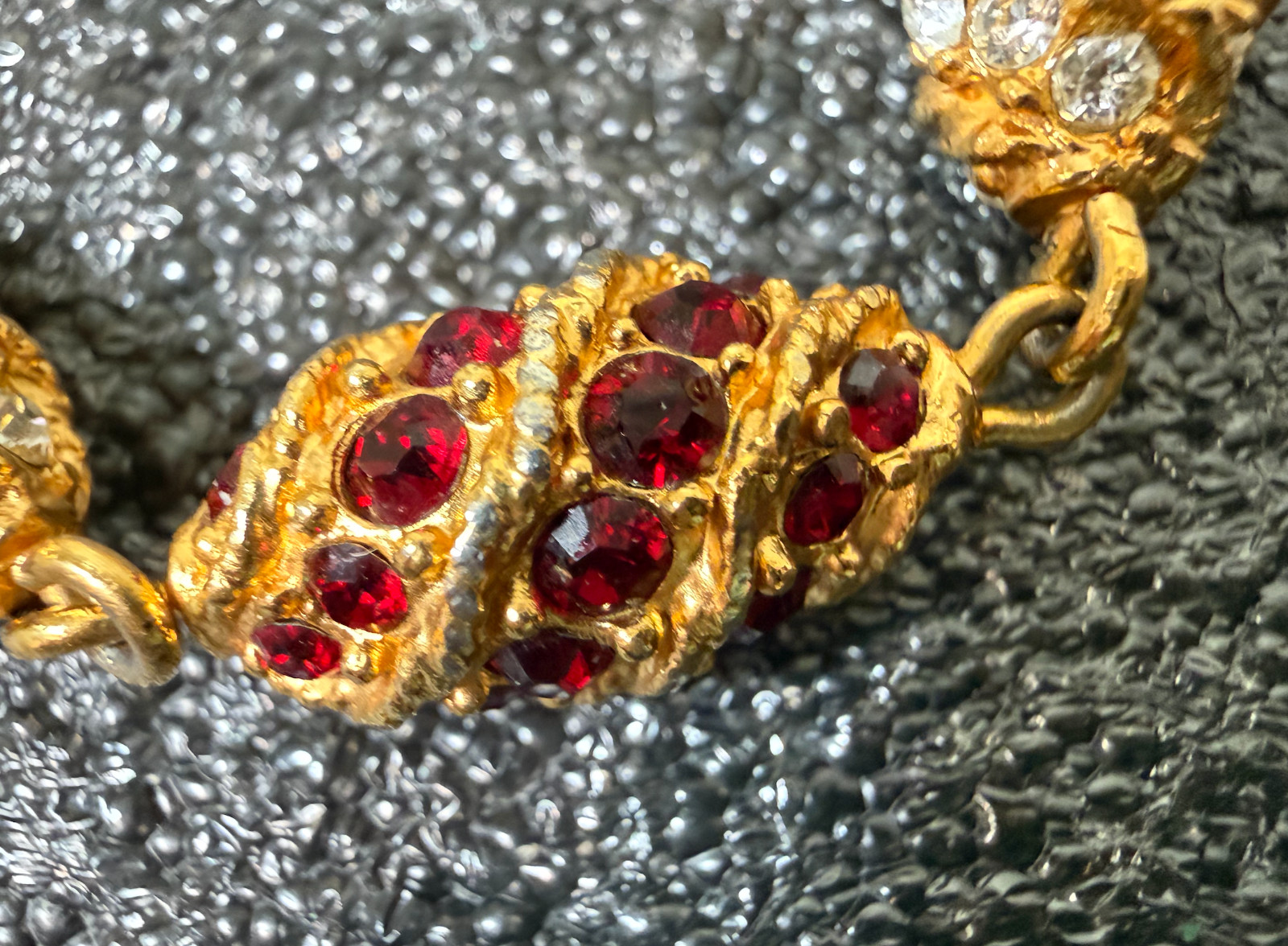 Gold tone bracelet egg shaped red, green blue, clear stones