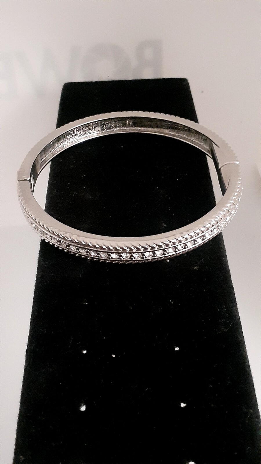 Cubic Zirconia Silvertone Bangle Bracelet. Magnetic closure. Signed China