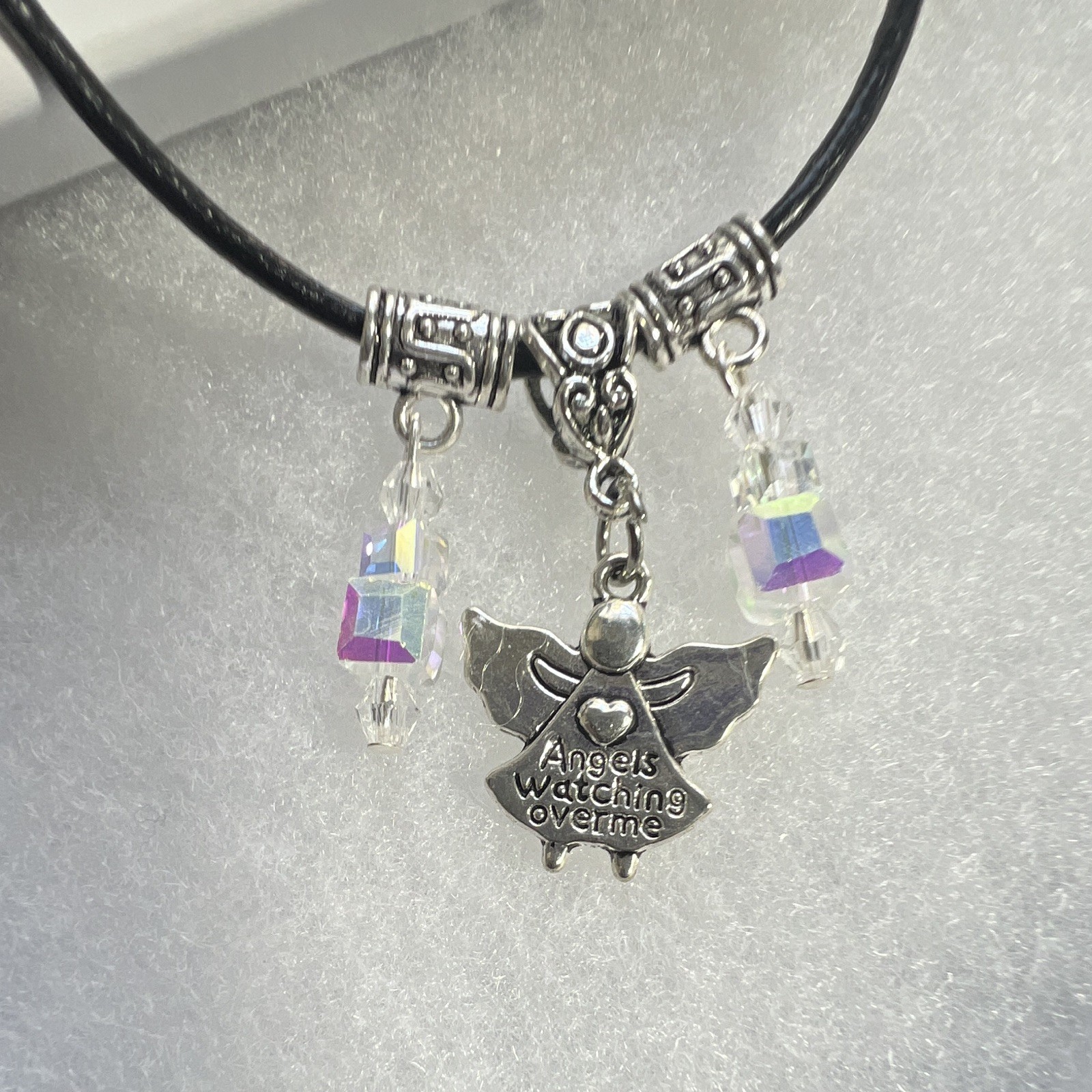 Angel pendant,inscribed, clear, crystal Aurora Borealis, leather lobster clasp.