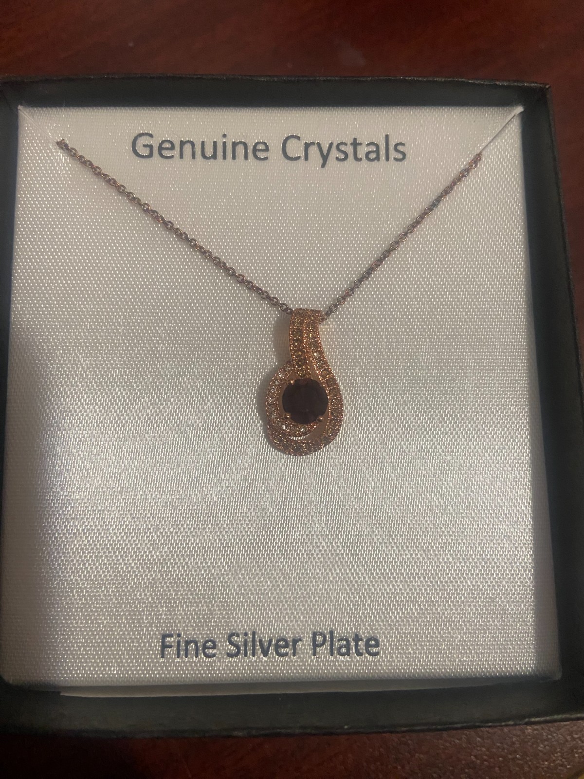 Gold Women’s Necklace with purple gemstone.