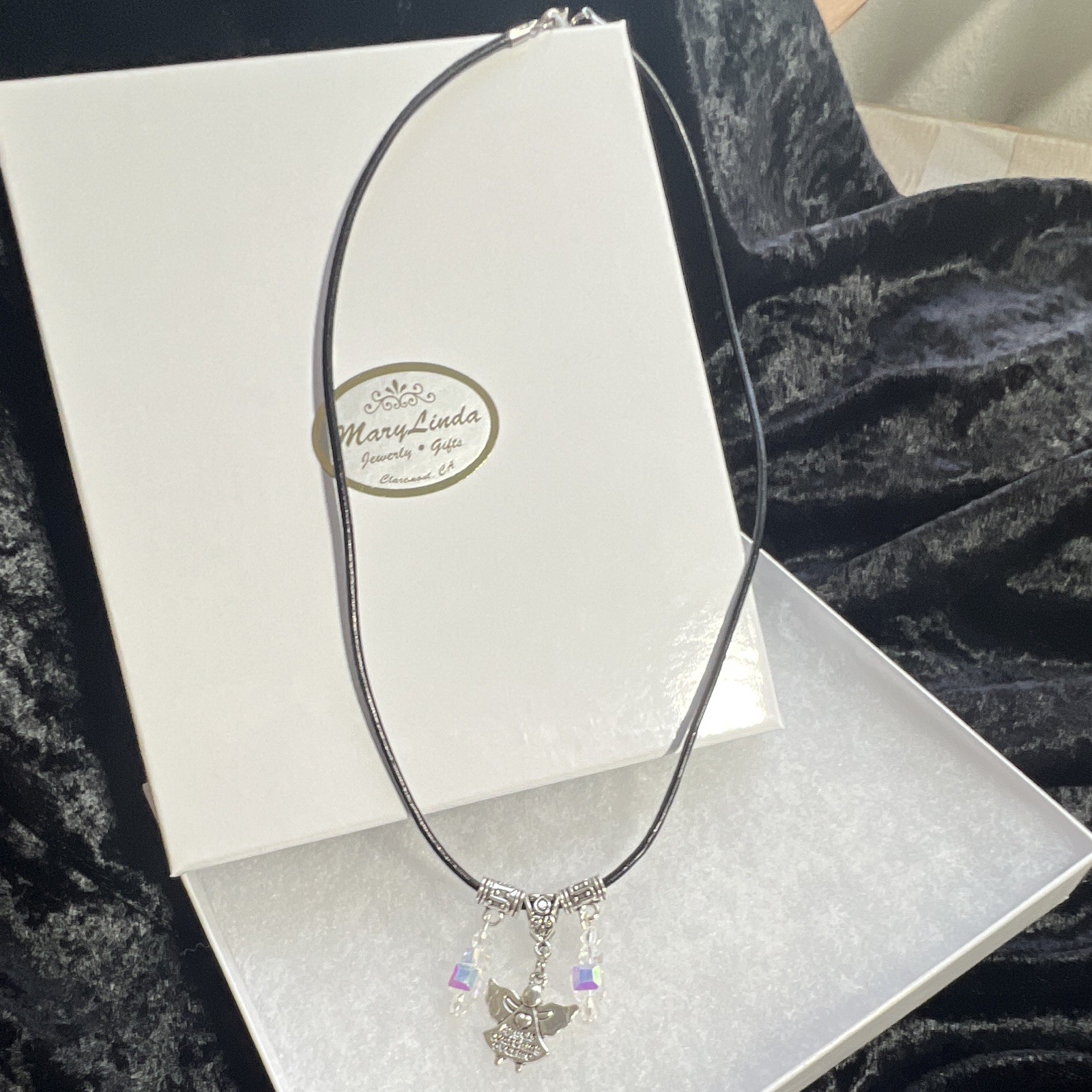 Angel pendant,inscribed, clear, crystal Aurora Borealis, leather lobster clasp.