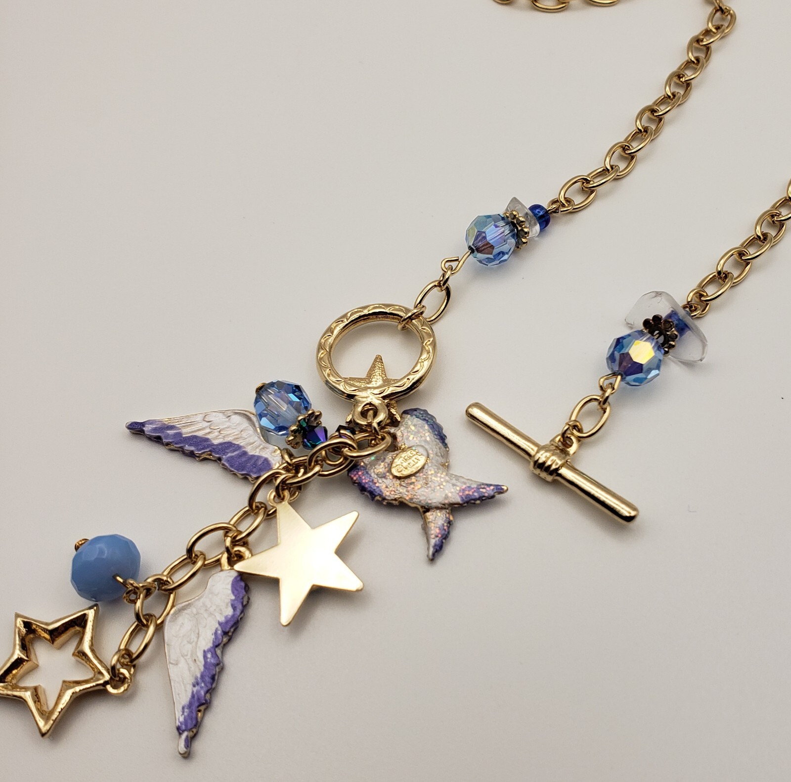 Kirks Folly Forever Angel Wings Charm Necklace Gold Tone 17in Long Blue Crystals