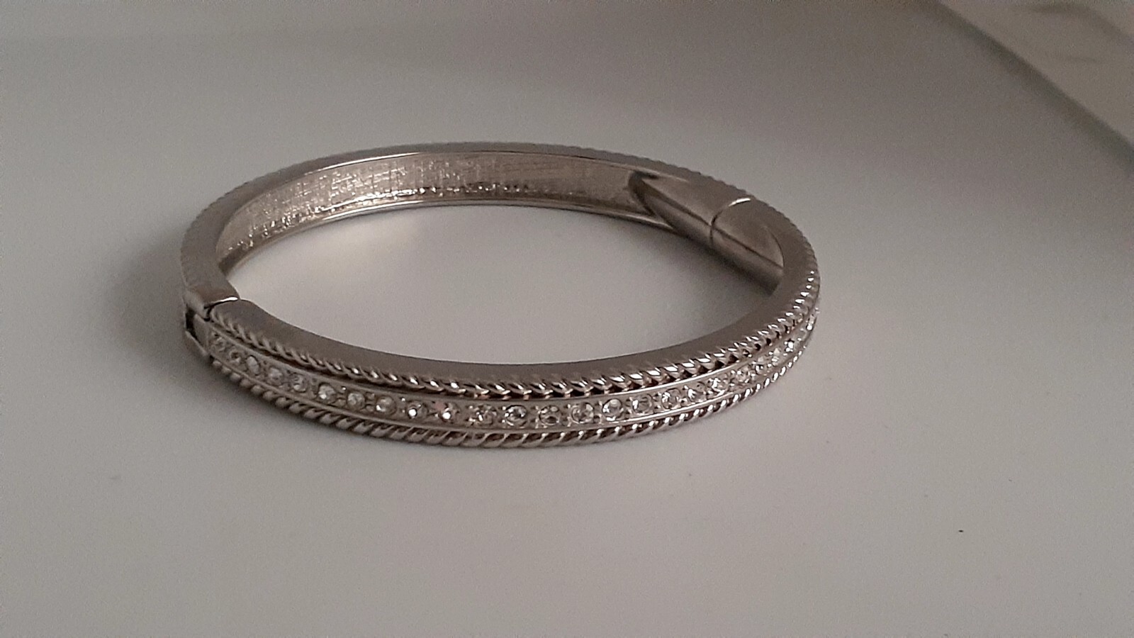 Cubic Zirconia Silvertone Bangle Bracelet. Magnetic closure. Signed China