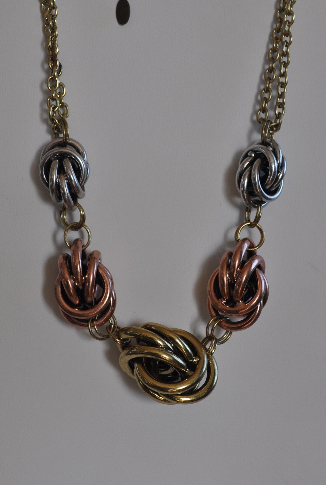 KIRKS FOLLY LOVE KNOT TRI COLOR GOLD, SILVER, ROSE TONE NECKLACE AND EARRING SET
