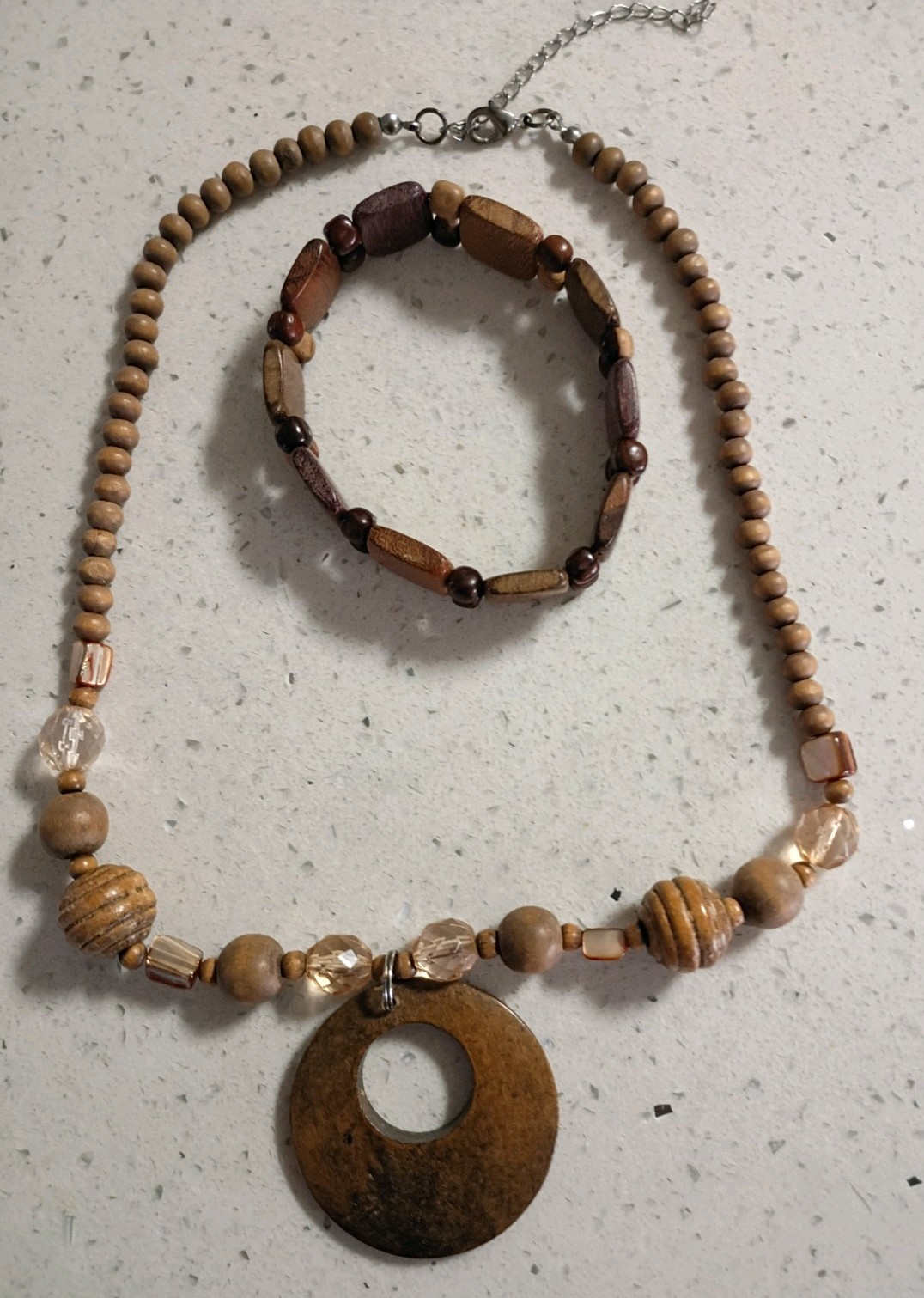 Brown wooden disc beaded necklace with lightweight wooden bracelet.