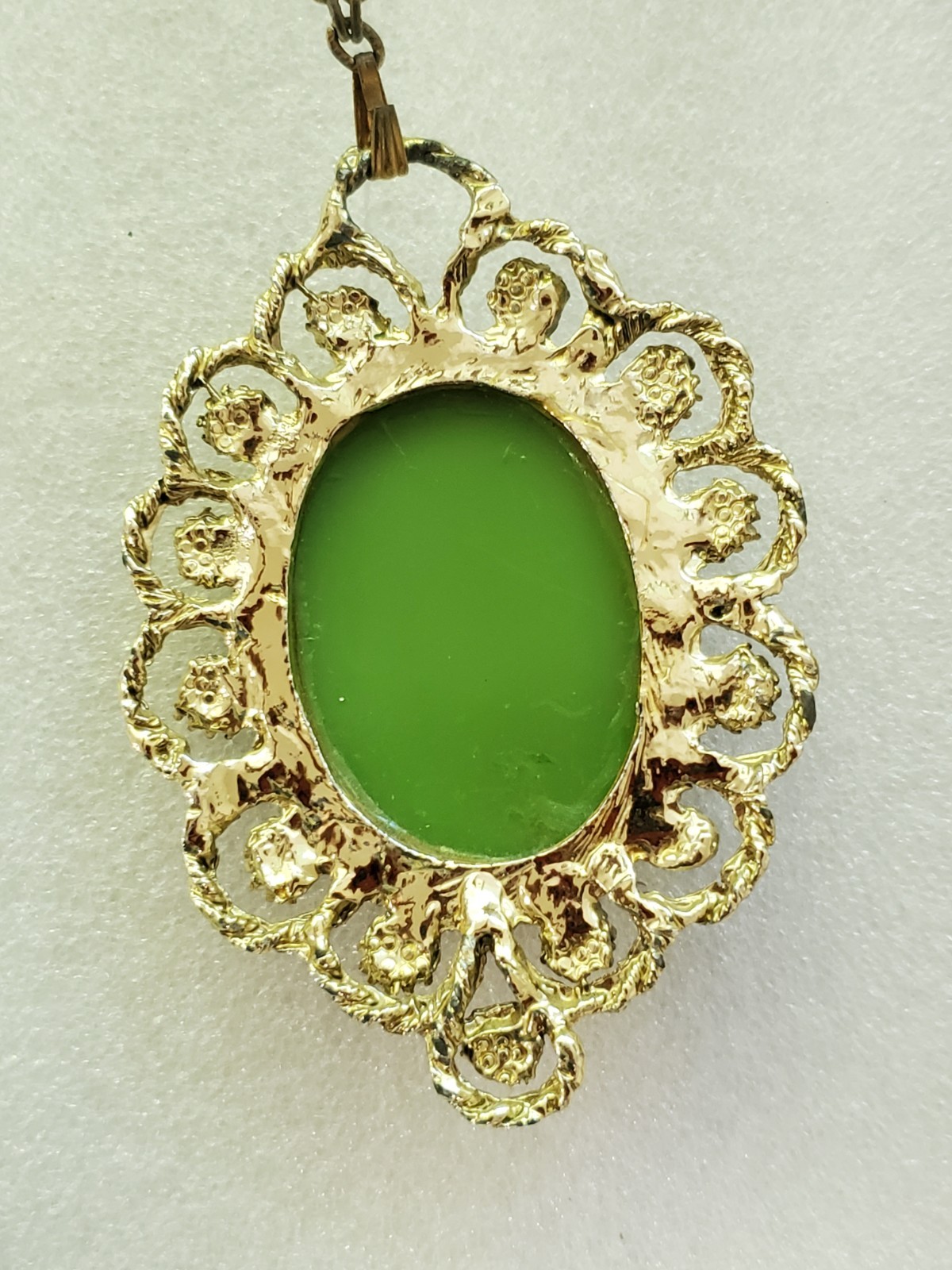 Gold-tone metal green/ivory plastic/resin cameo pendant & clip on earrings