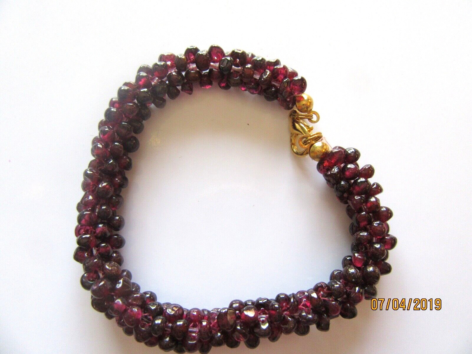 Fashion bracelet -small beads- purplish red color-gold tone-braided look