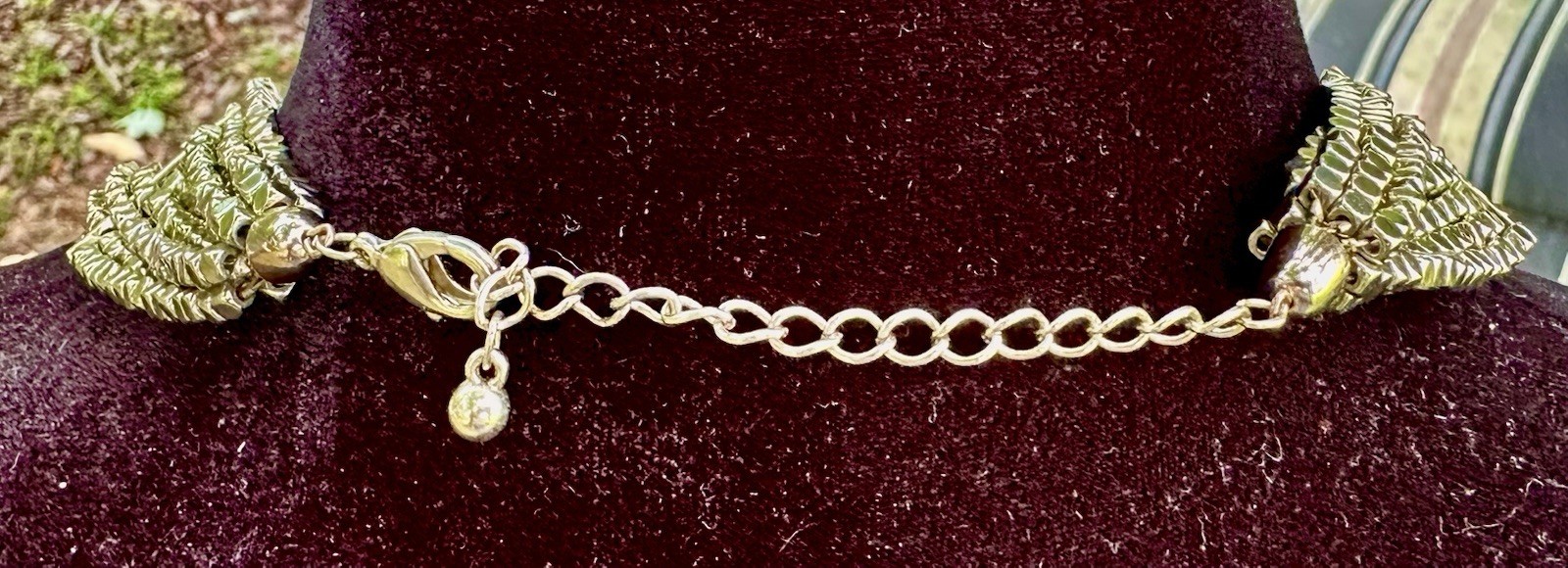 multi-strand bib necklace appears to be crafted from metallic-plated hematite