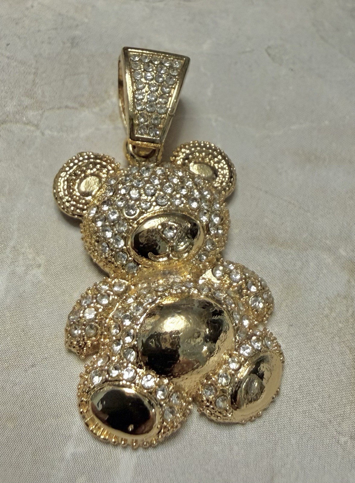 Gold Tone Teddy Bear Charm Covered In Sparkling Diamond Simulants.