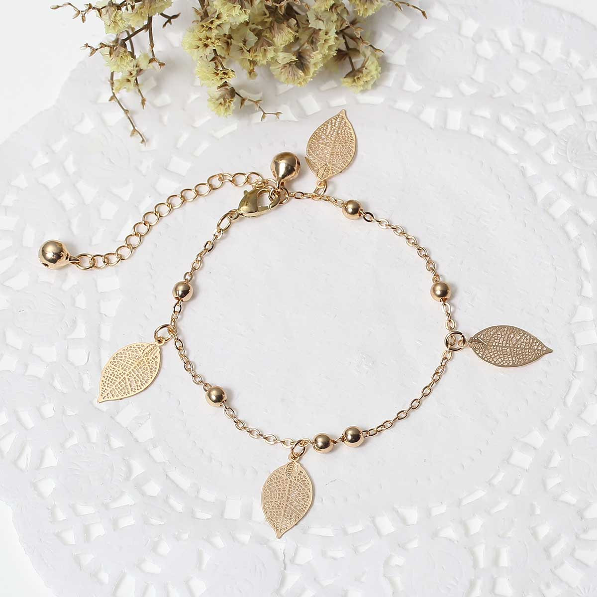 SEXY SPARKLES Filigree Stamping Bell Bracelet Gold Plated Whit Hollow Leaf Pend