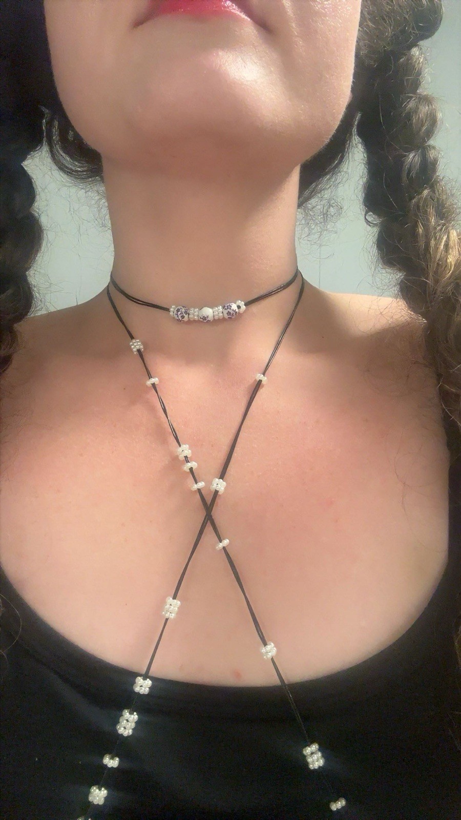 Black leather choker with nipple ring attachments. For pierced nipples only.