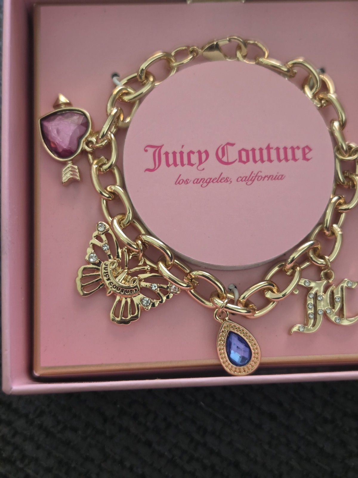 Juicy Couture Gold Charm Bracelet with Blue and Black Accents