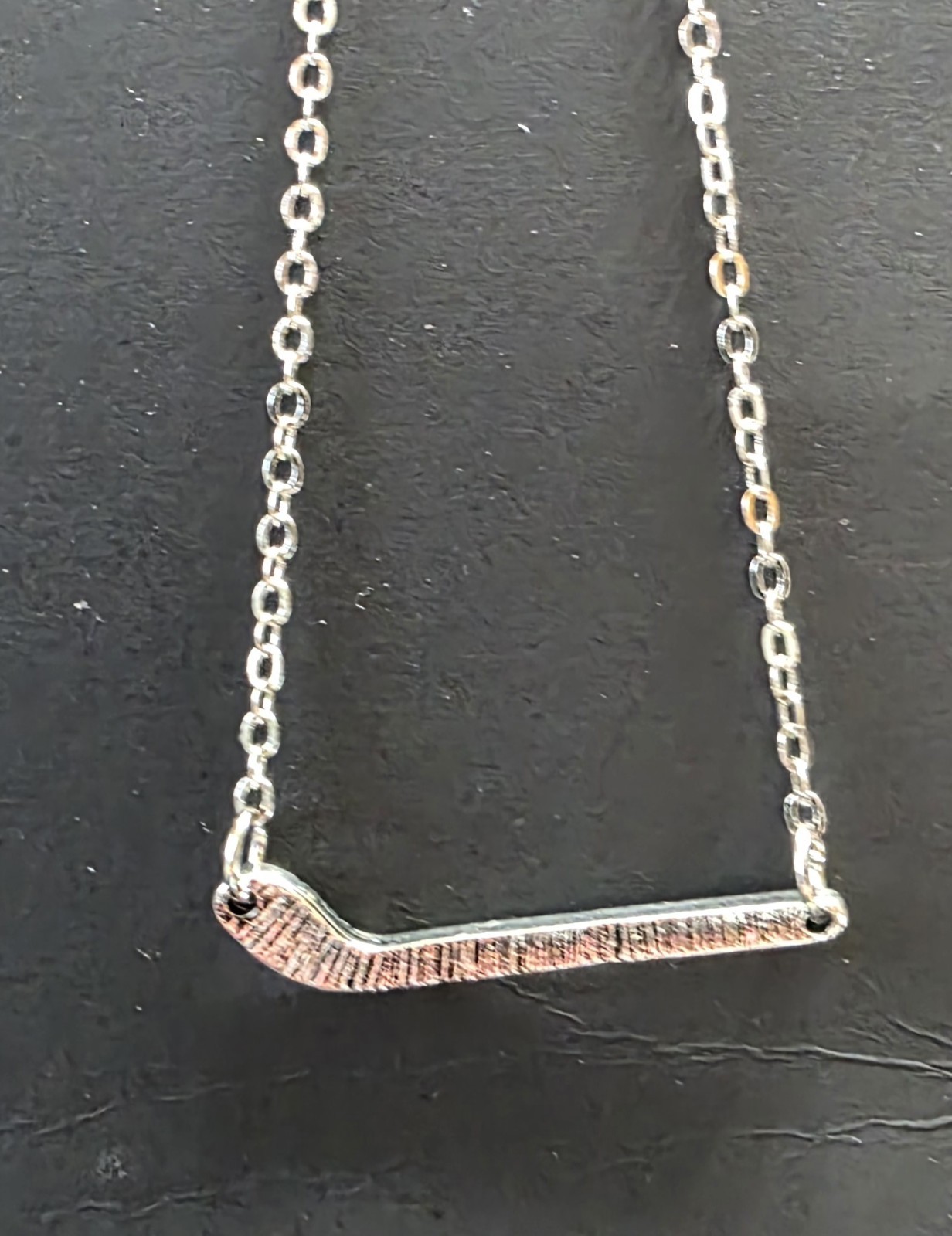 Silver Toned Hockey Stick necklace. 18″ w/ 2.5″ extender