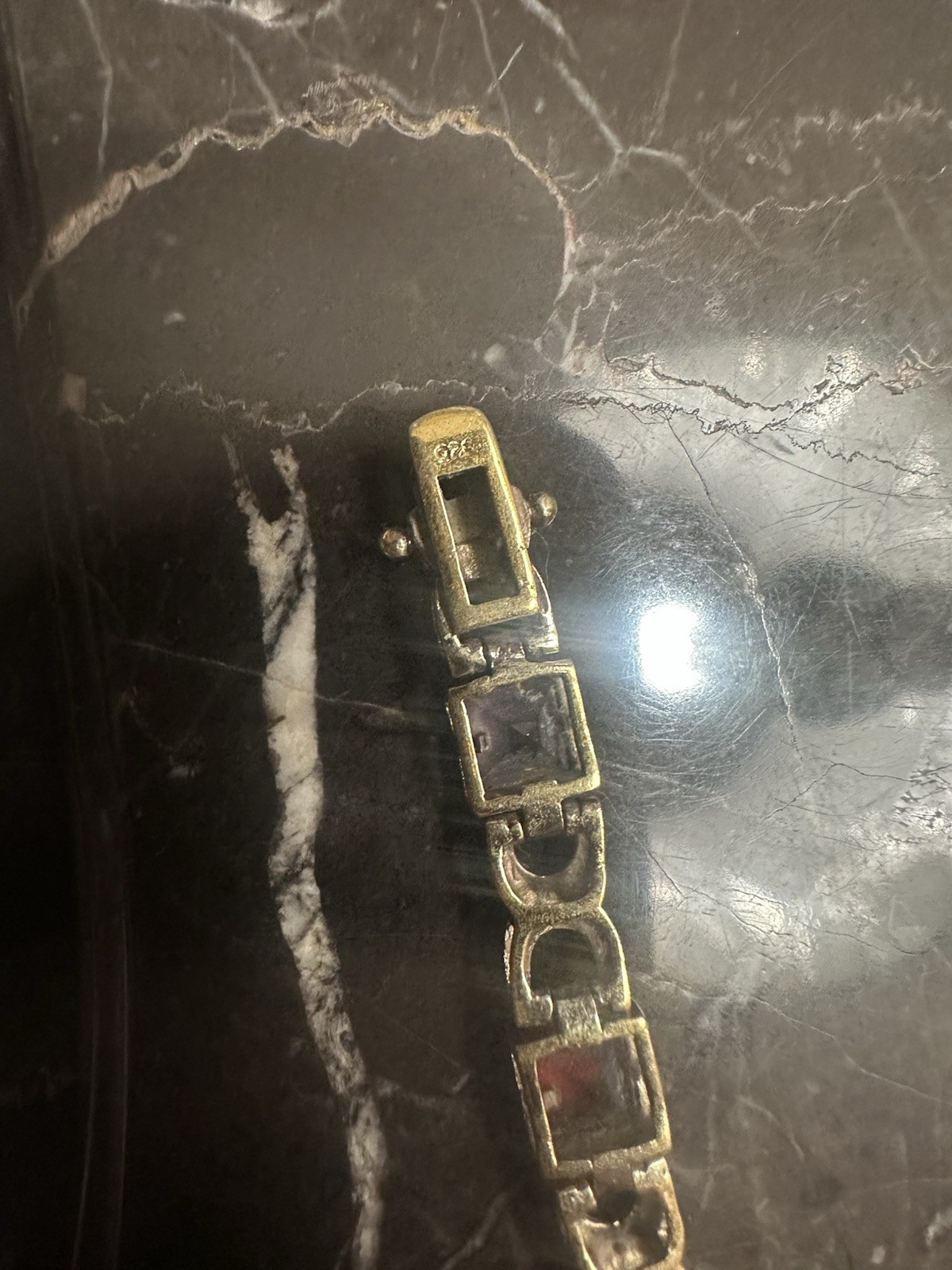 Gold Plated link bracelet with assorted square gemstones and a bezel box clasp.