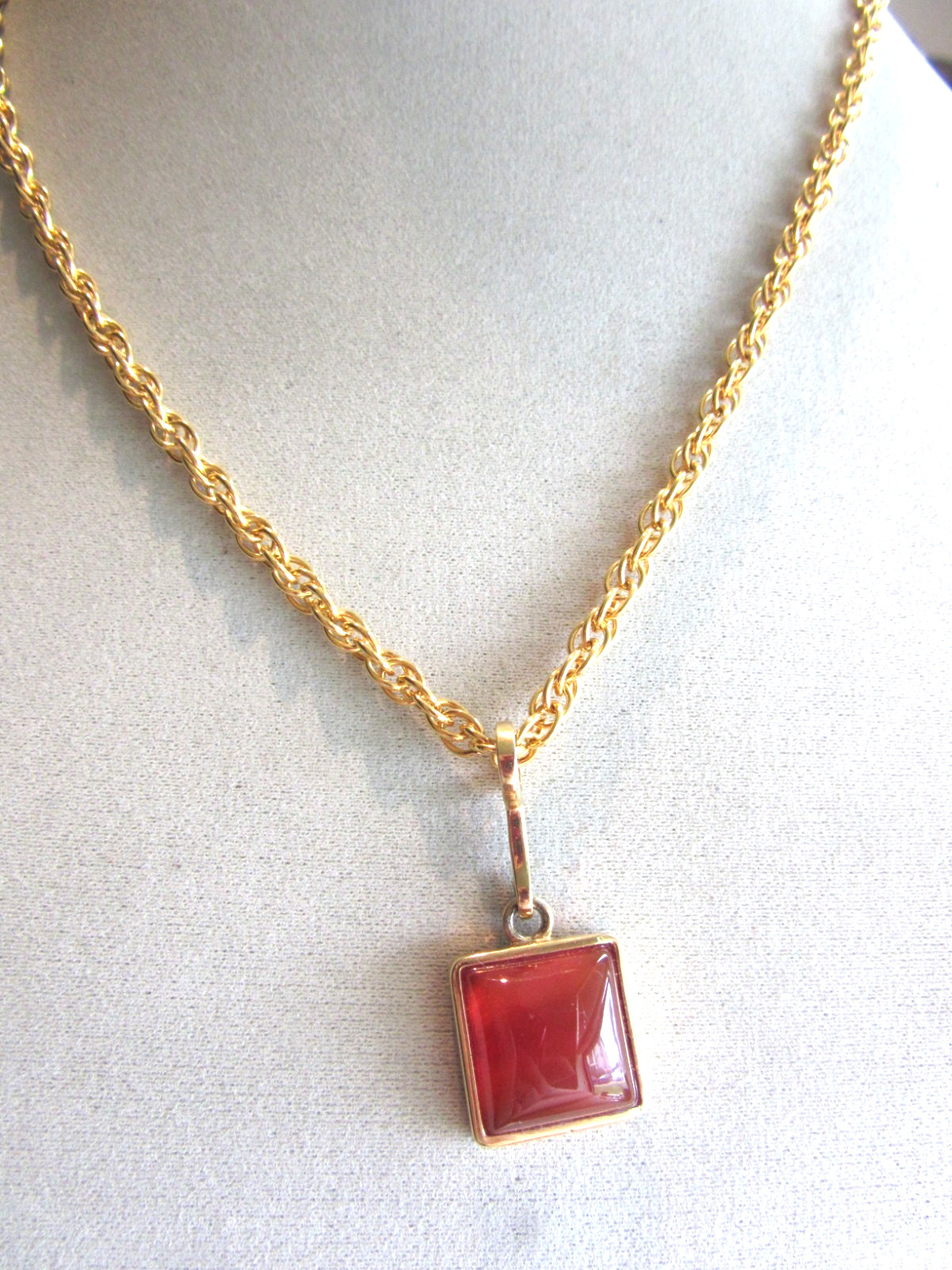 Gold tone rope chain necklace with Roman brand carnelian pendant