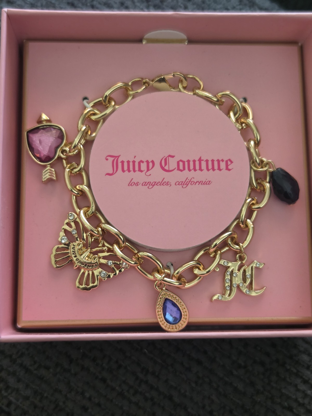 Juicy Couture Gold Charm Bracelet with Blue and Black Accents
