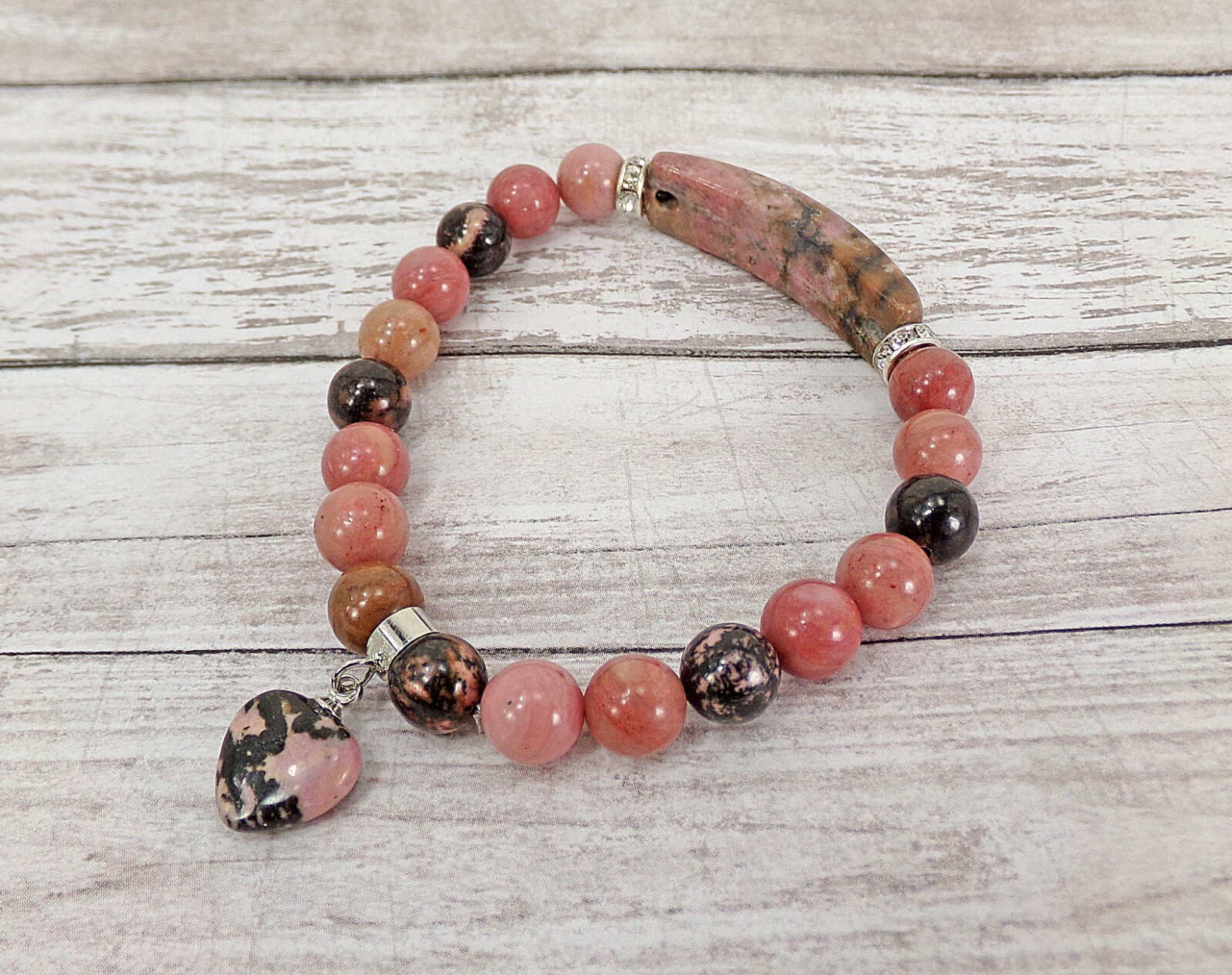 Pink heart charm bracelet made in rhodonite stone beads and crystal spacer beads