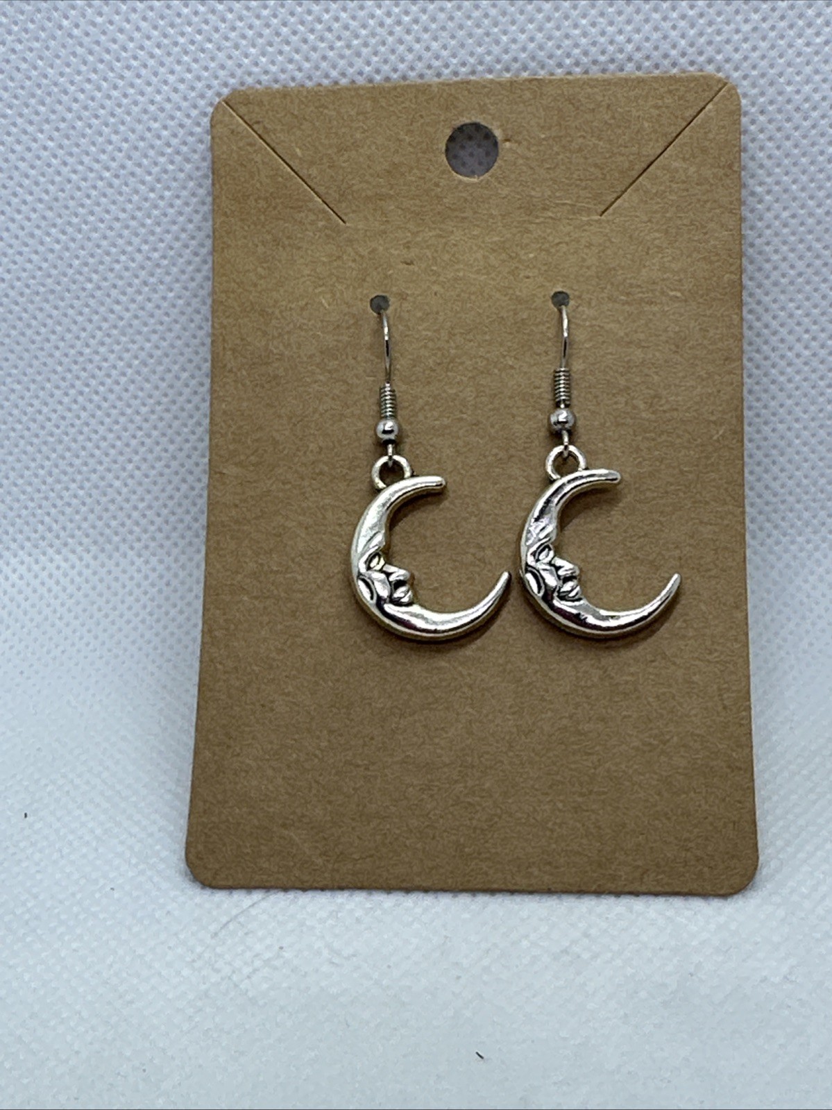 1″x1″ moon face dangling earrings