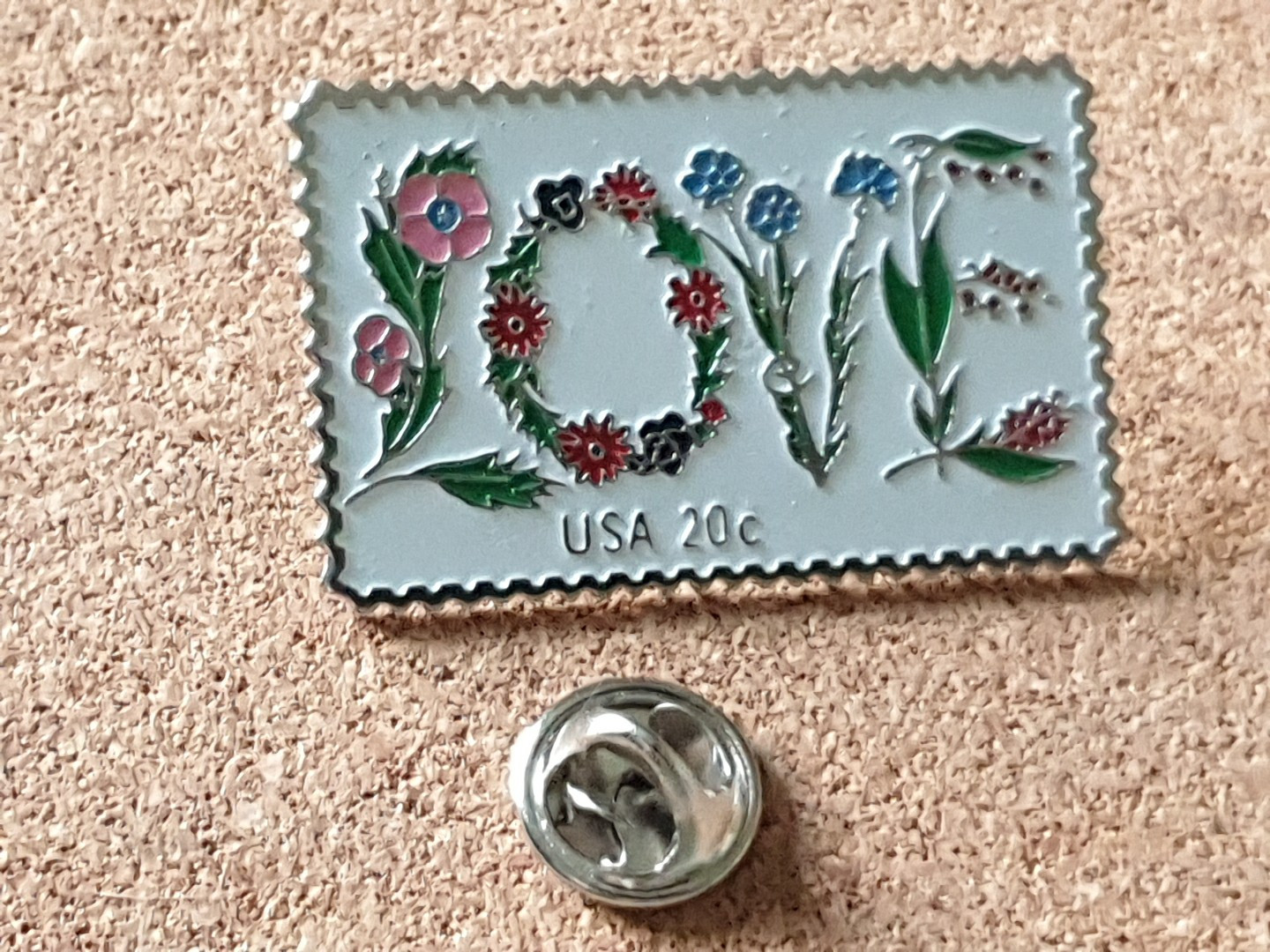 The March Co USPS 20c 1982 LOVE Stamp Floral Embossed Lapel Pin Back