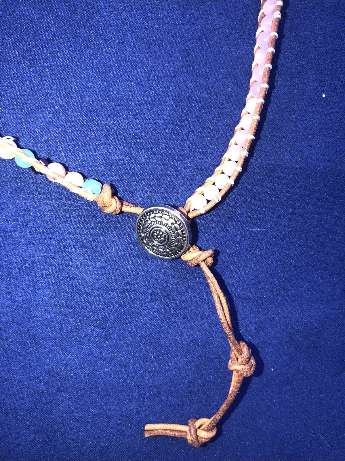 A 37” long necklace ,￼￼ a Bohemian or Hippie emphasizing made of leather, gems.w
