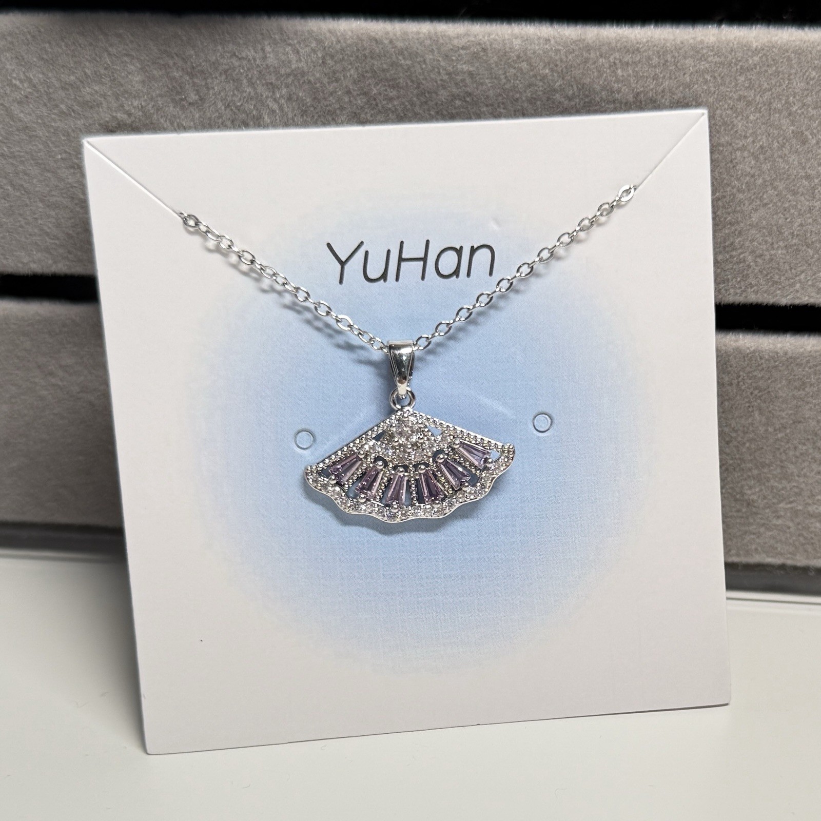 Purple rhinestone fan-shaped pendant with 18″ adjustable length necklace.