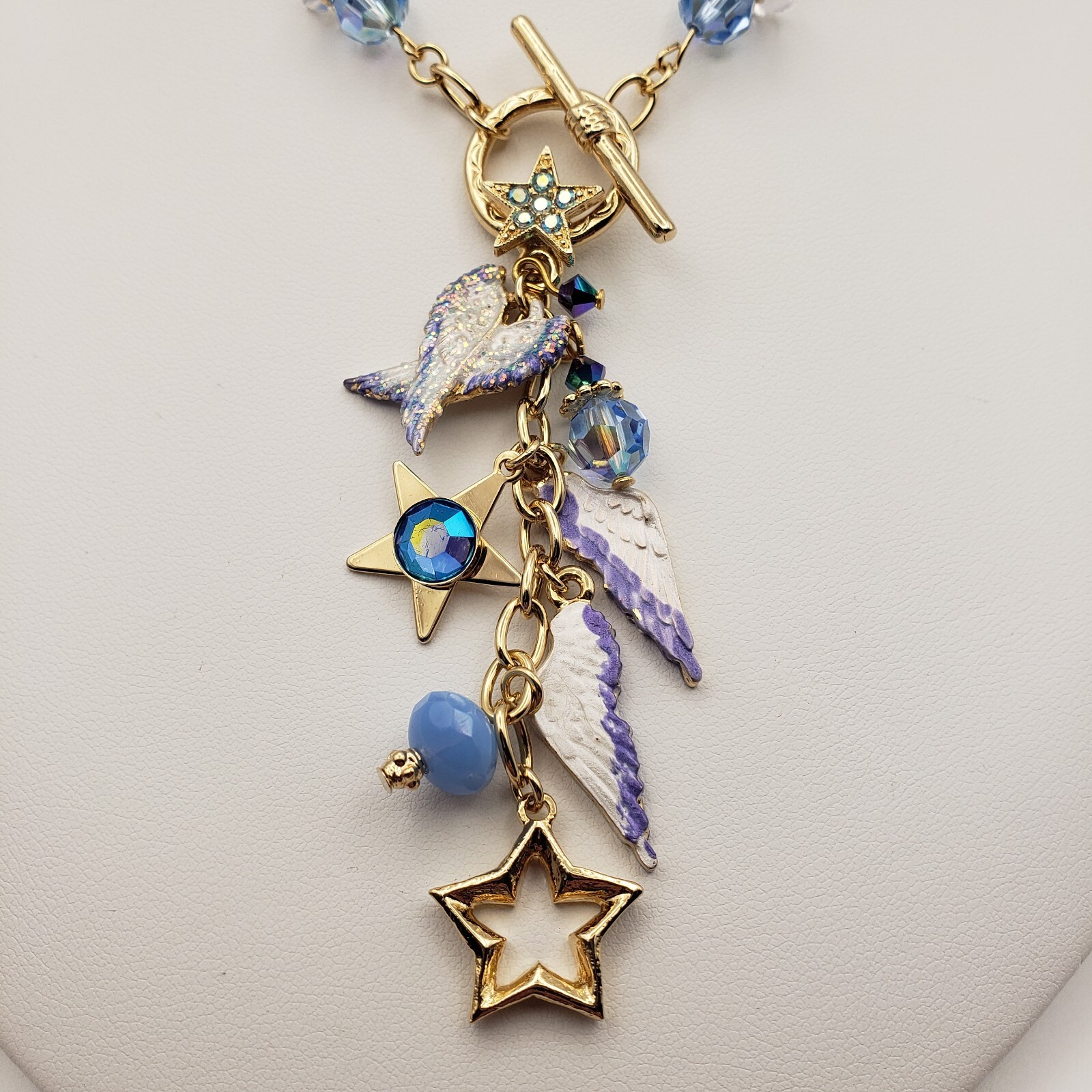 Kirks Folly Forever Angel Wings Charm Necklace Gold Tone 17in Long Blue Crystals