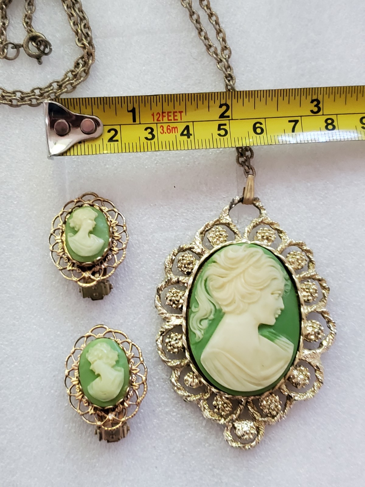 Gold-tone metal green/ivory plastic/resin cameo pendant & clip on earrings