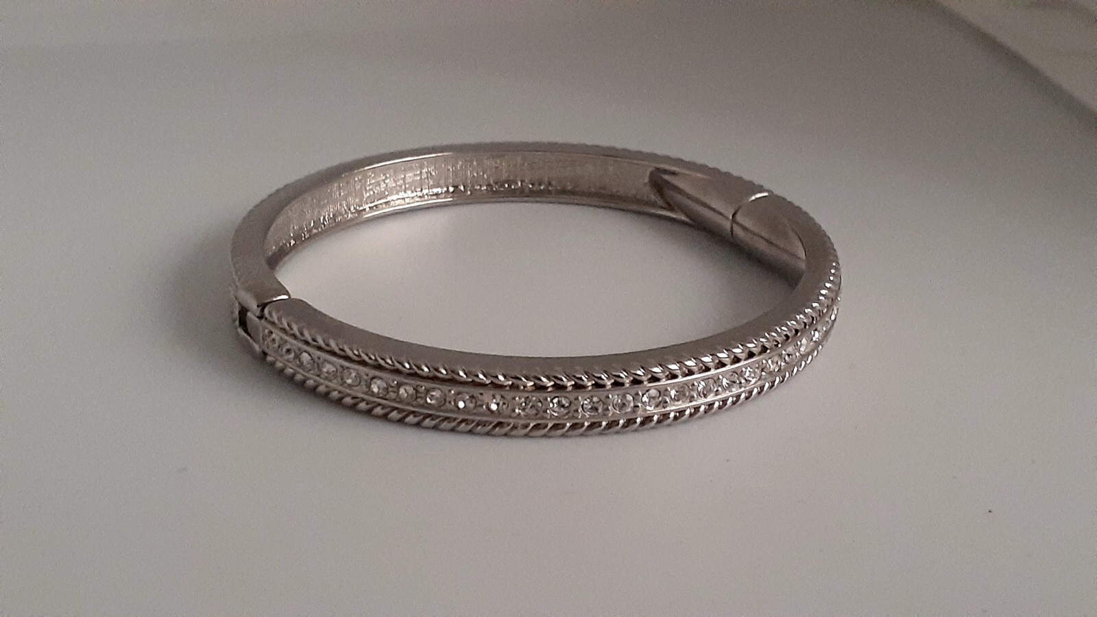 Cubic Zirconia Silvertone Bangle Bracelet. Magnetic closure. Signed China