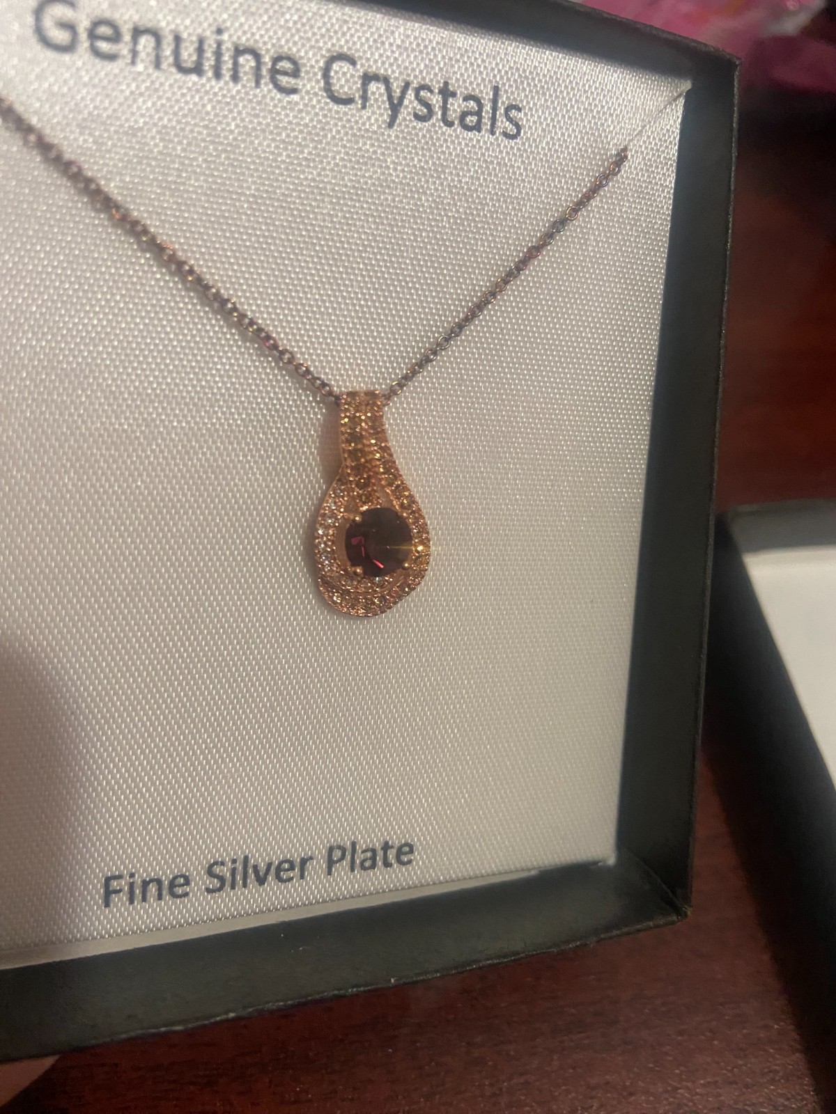 Gold Women’s Necklace with purple gemstone.