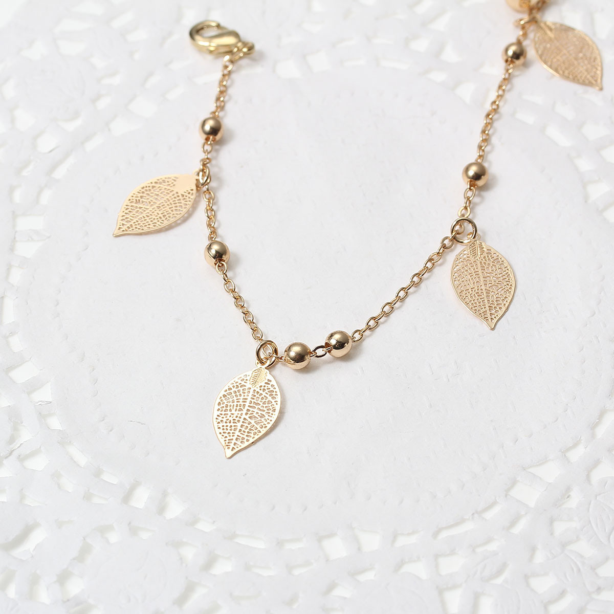 SEXY SPARKLES Filigree Stamping Bell Bracelet Gold Plated Whit Hollow Leaf Pend