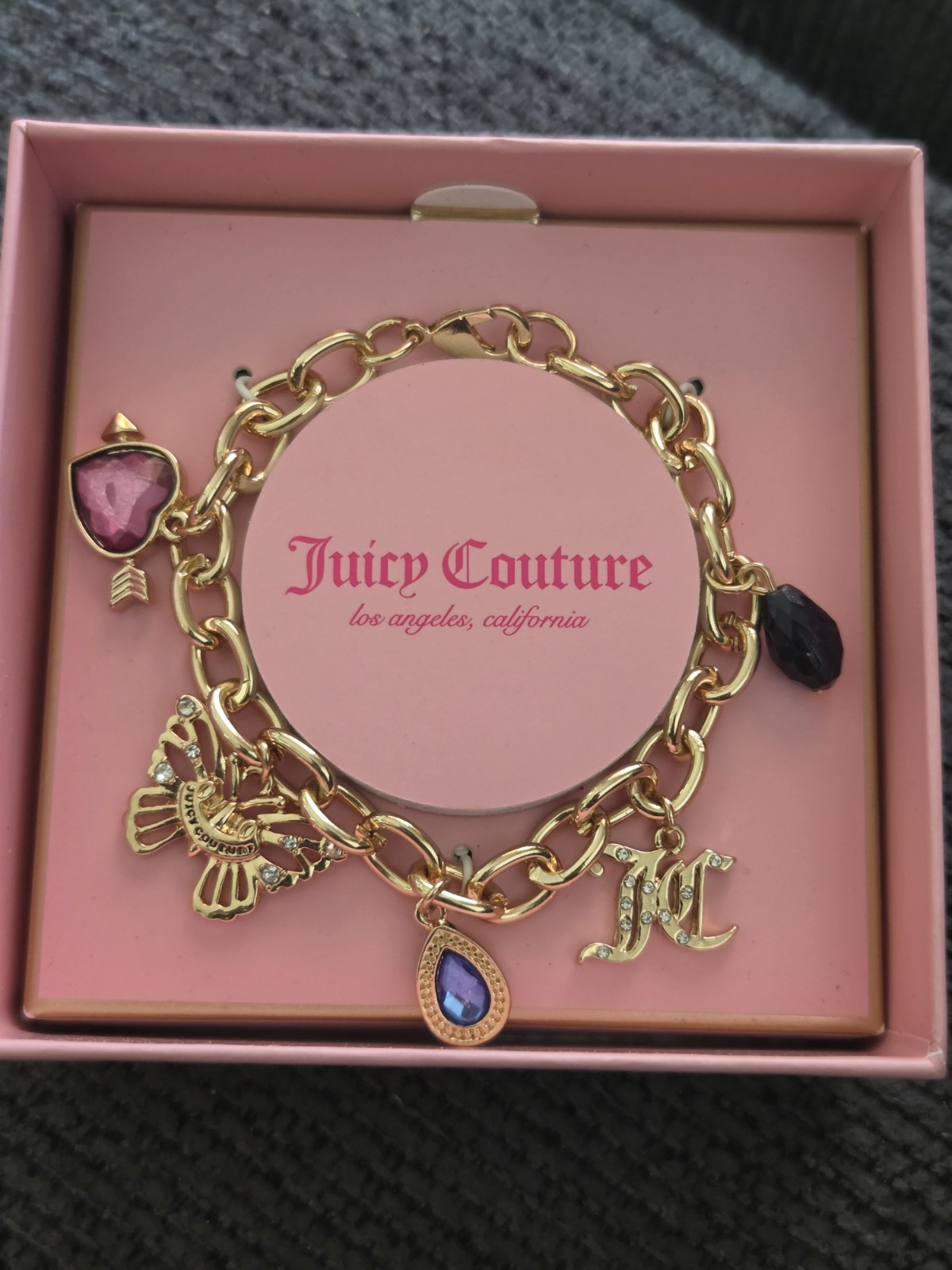 Juicy Couture Gold Charm Bracelet with Blue and Black Accents