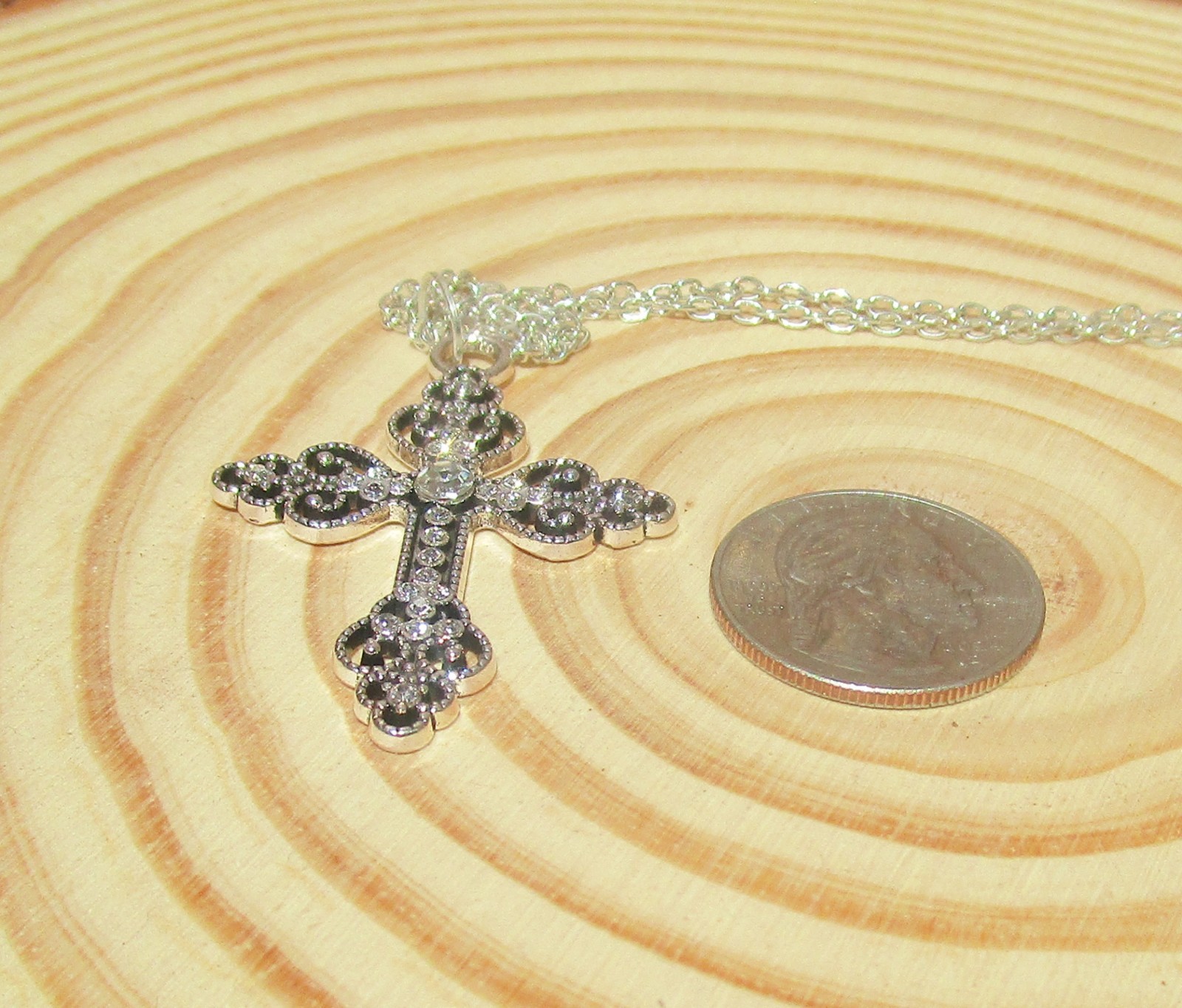 silver color ornate cross necklace for women