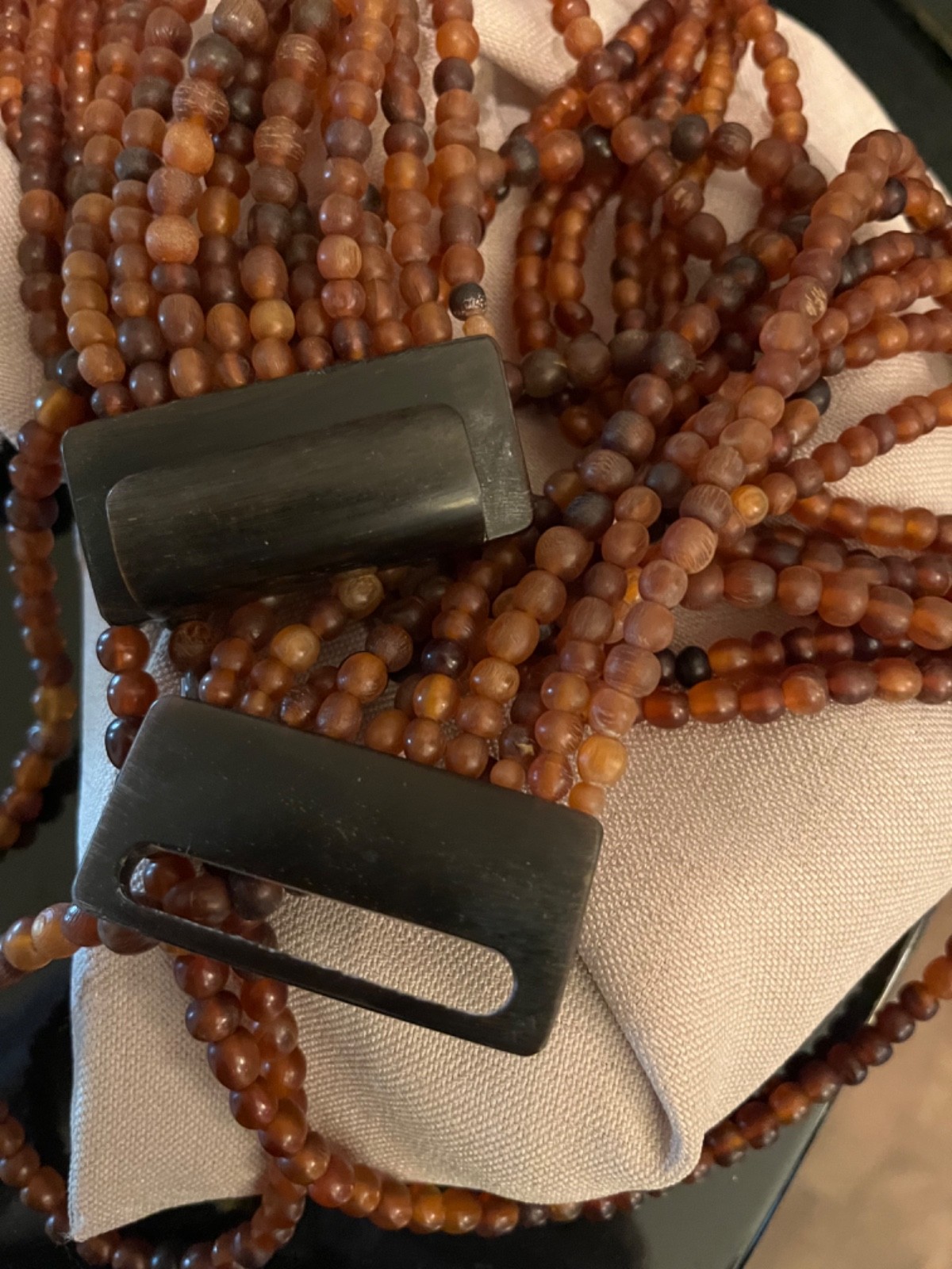 Multilayer warm brown draped necklace possibly acrylic brown clasp