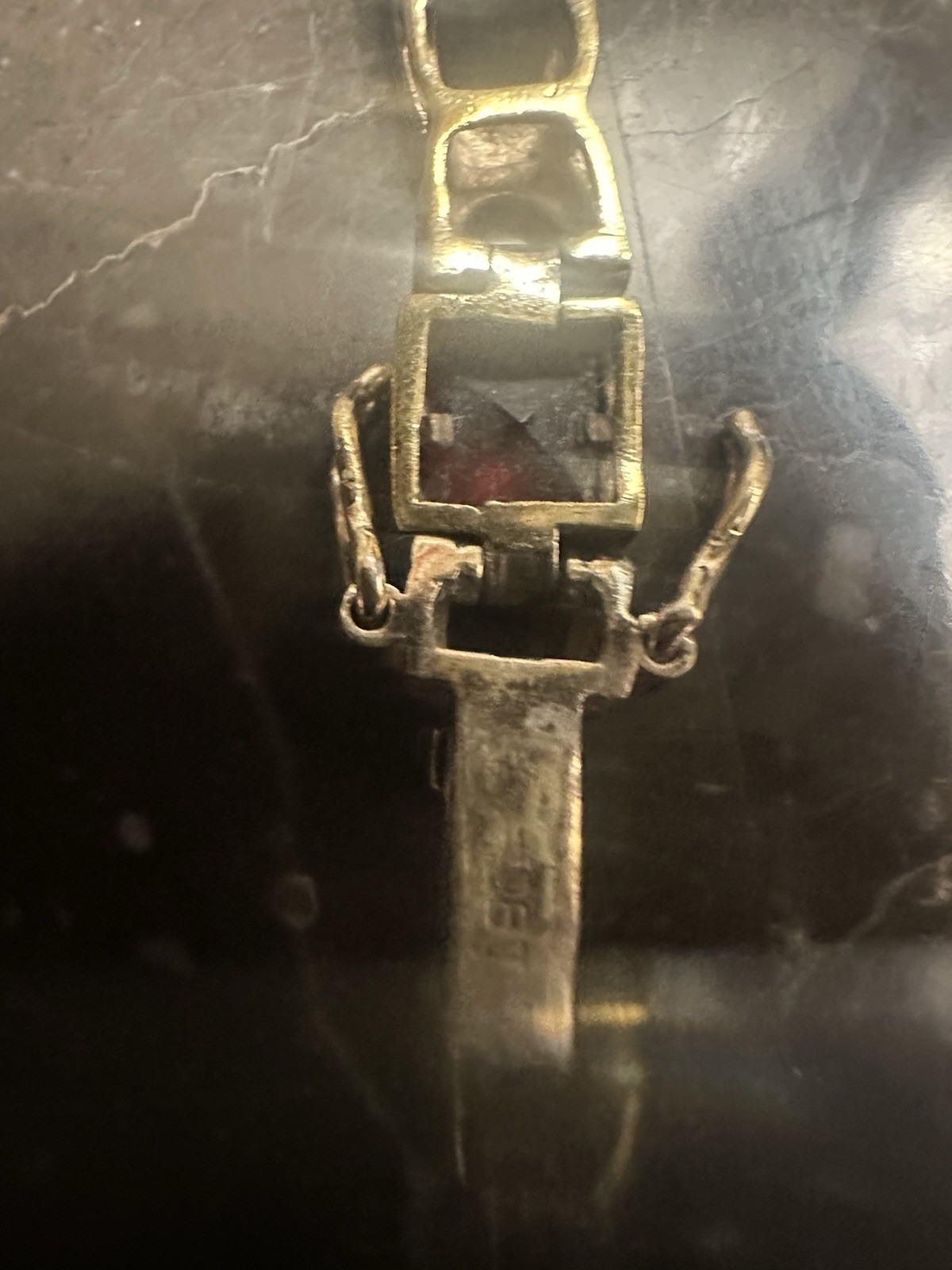Gold Plated link bracelet with assorted square gemstones and a bezel box clasp.