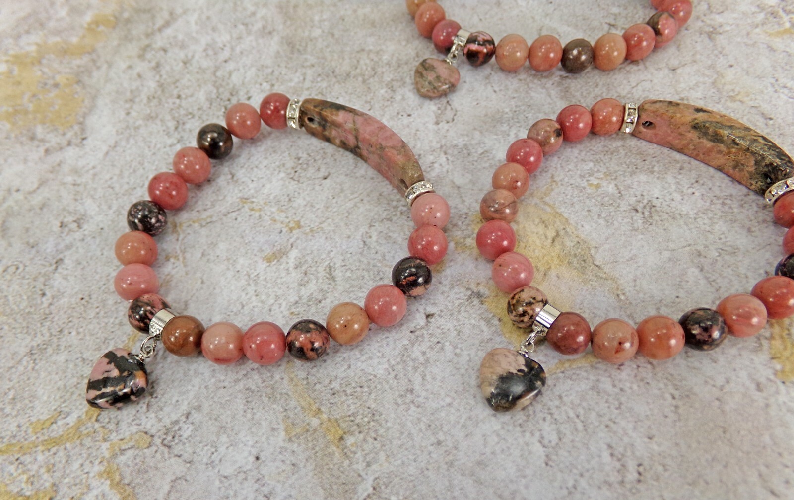Pink heart charm bracelet made in rhodonite stone beads and crystal spacer beads